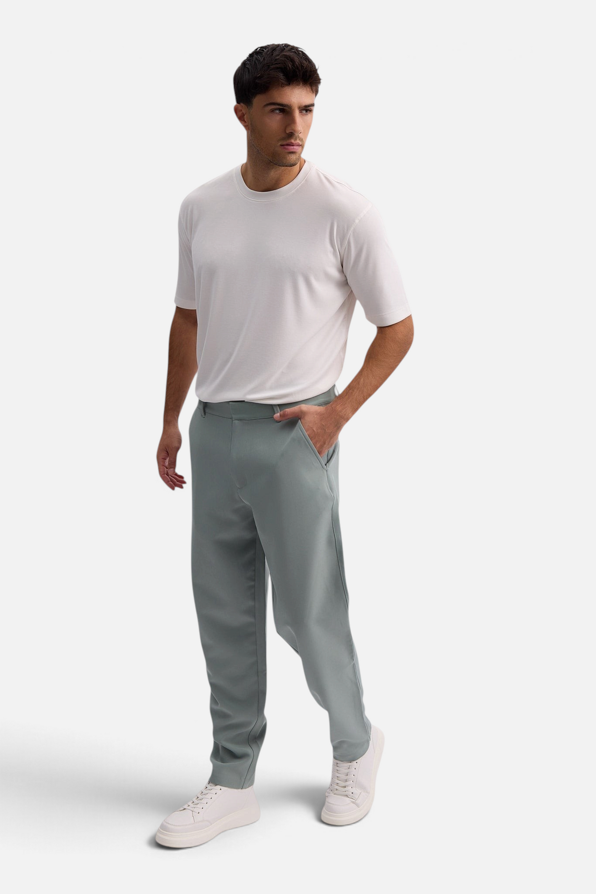 Mainstreamonline Santo Pants in sage green with a loose, wide-leg tailored fit worn by a man with a white t-shirt.