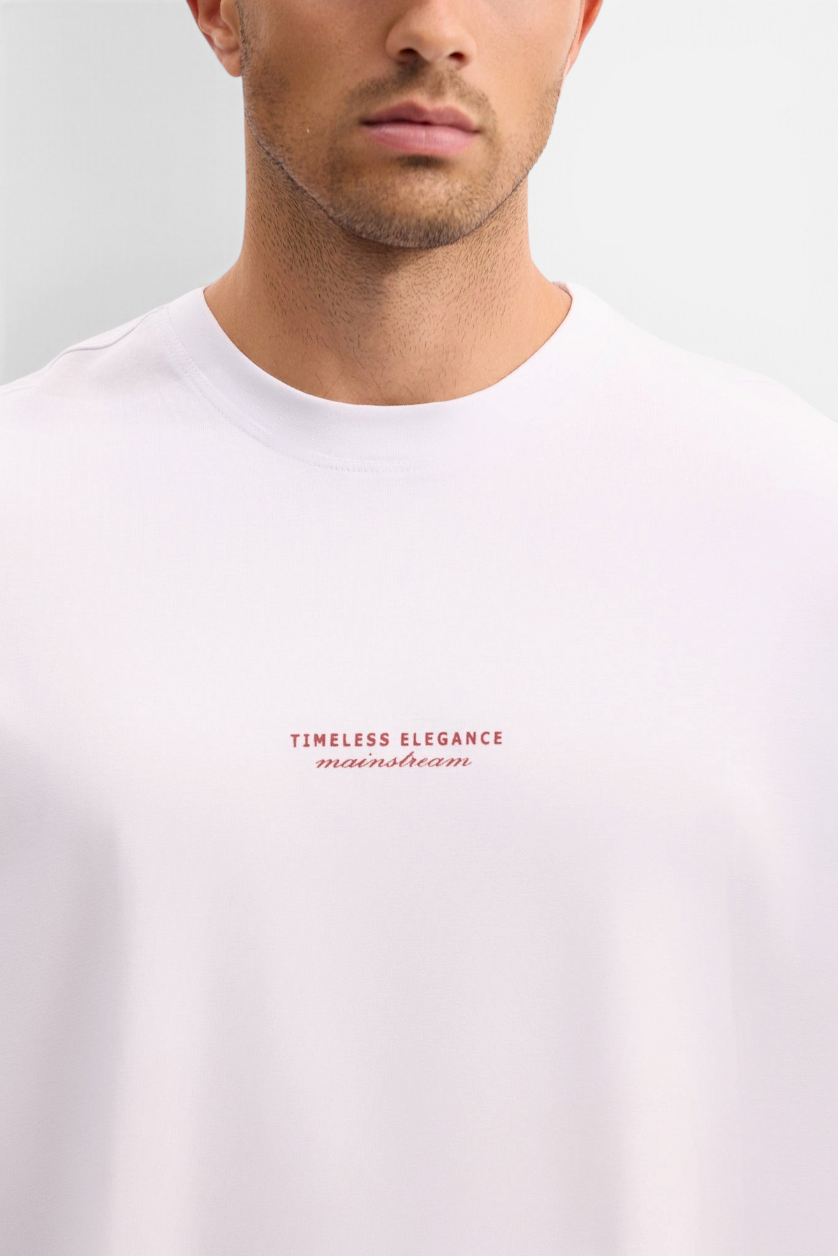 Mainstreamonline white oversized t-shirt with Timeless Elegance text print on the chest