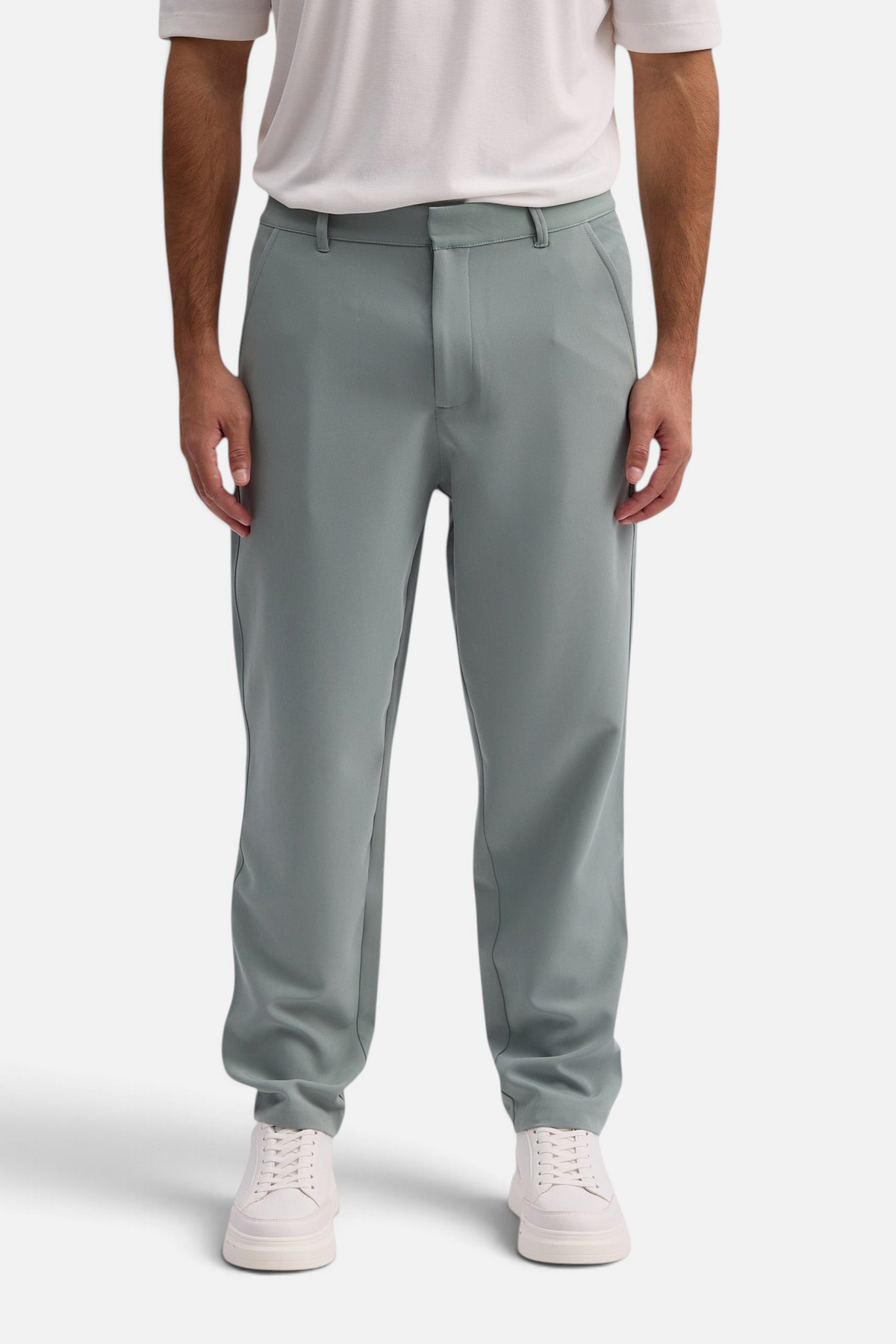 Mainstreamonline Santo Pants in sage green with a relaxed wide-leg fit and tailored silhouette on a male model