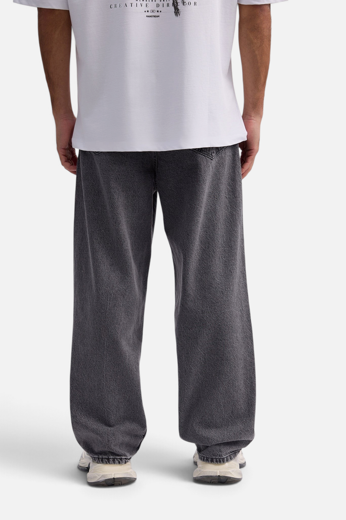 Mainstreamonline baggy skater jeans in washed charcoal grey with a loose, relaxed fit, back view on a model.