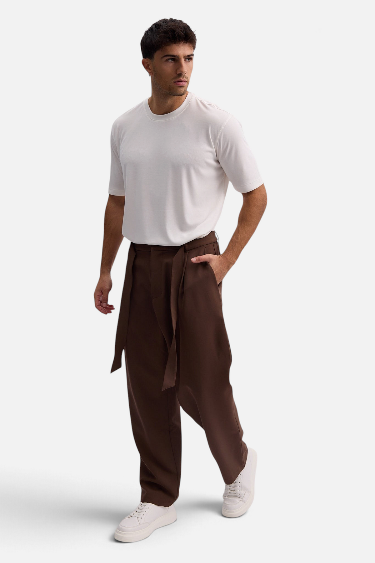 Mainstreamonline Torino wide-leg brown trousers with a tie waist worn by a man with a white t-shirt and sneakers