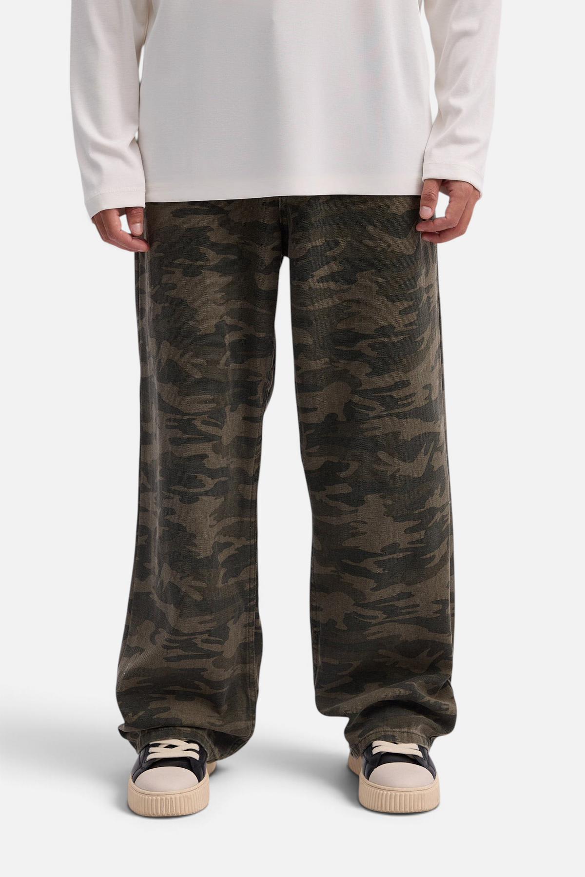 Mainstreamonline baggy army jeans in green camouflage print with a loose, relaxed fit worn by a model.