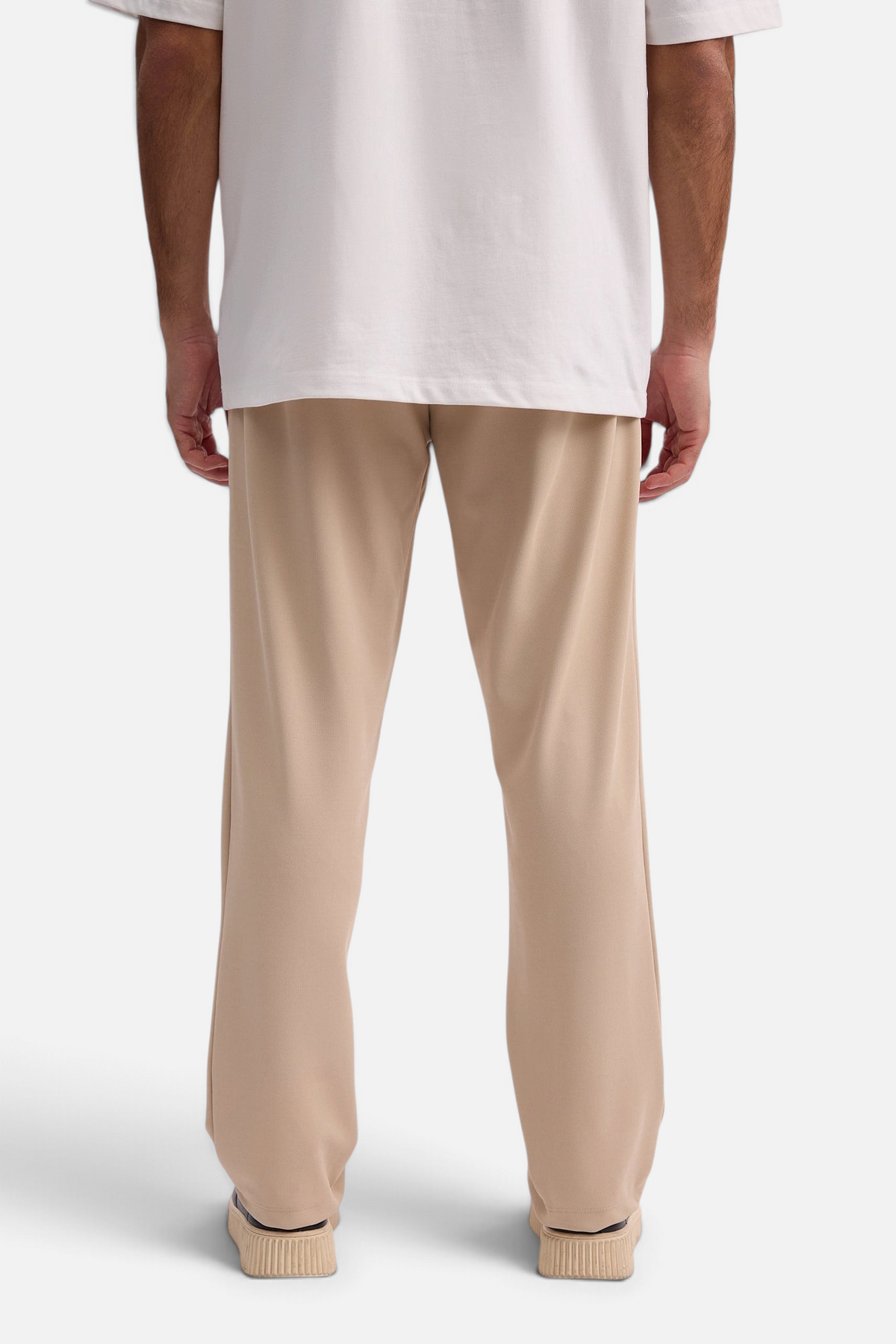 Mainstreamonline Sol Pants in beige featuring a relaxed straight-leg fit and elastic waist, back view.
