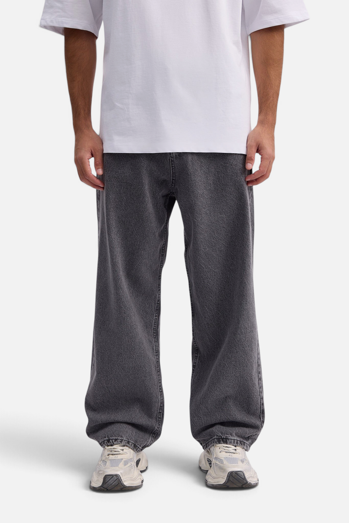 Mainstreamonline baggy skater jeans in washed charcoal grey with a loose, wide-leg fit on a model