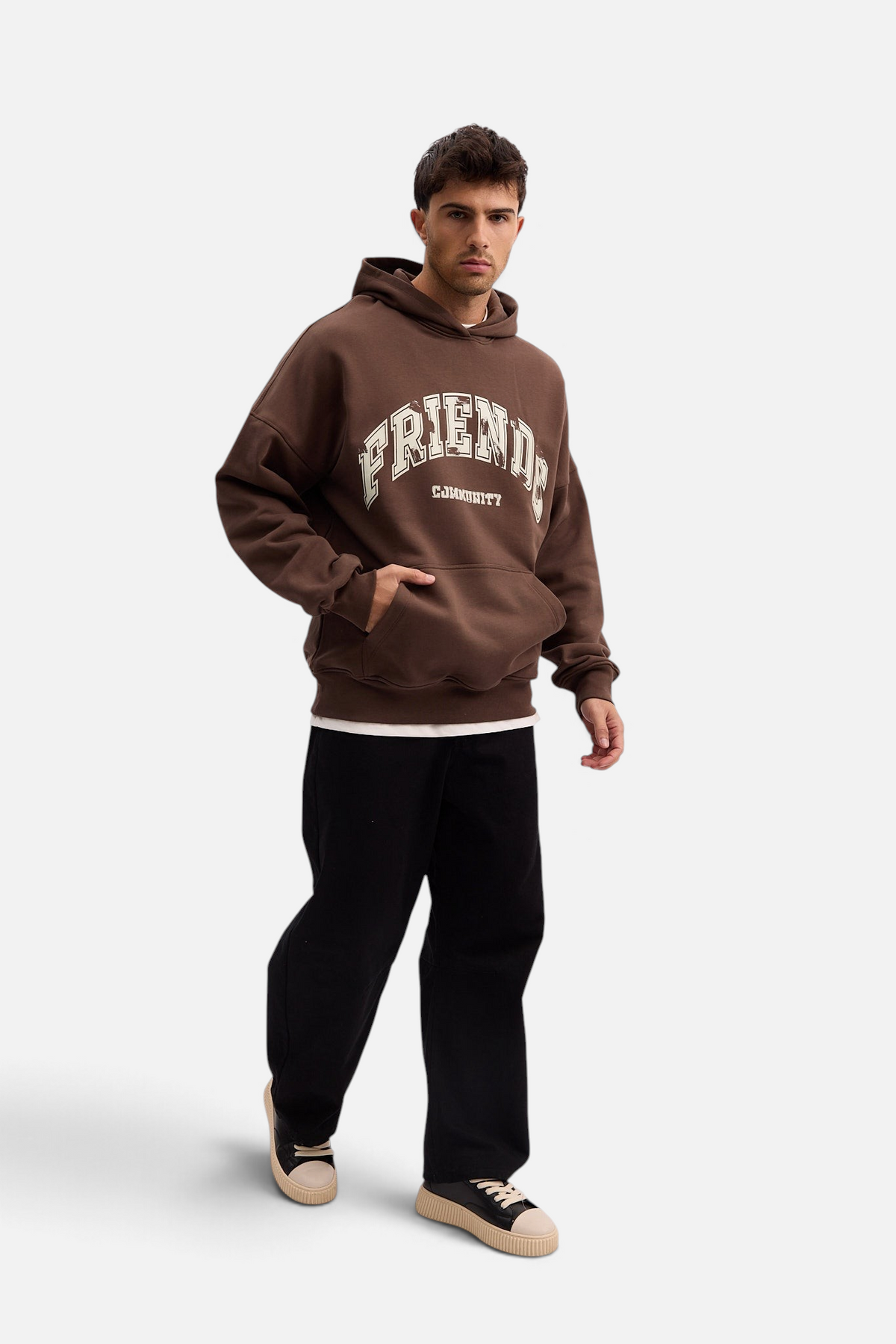 Mainstreamonline brown oversized hoodie with Friends graphic print, worn by a male model with black pants