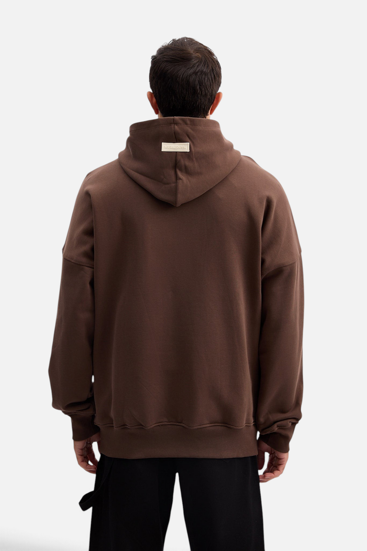 Mainstreamonline brown oversized hoodie with a relaxed fit and branded label on the hood, back view