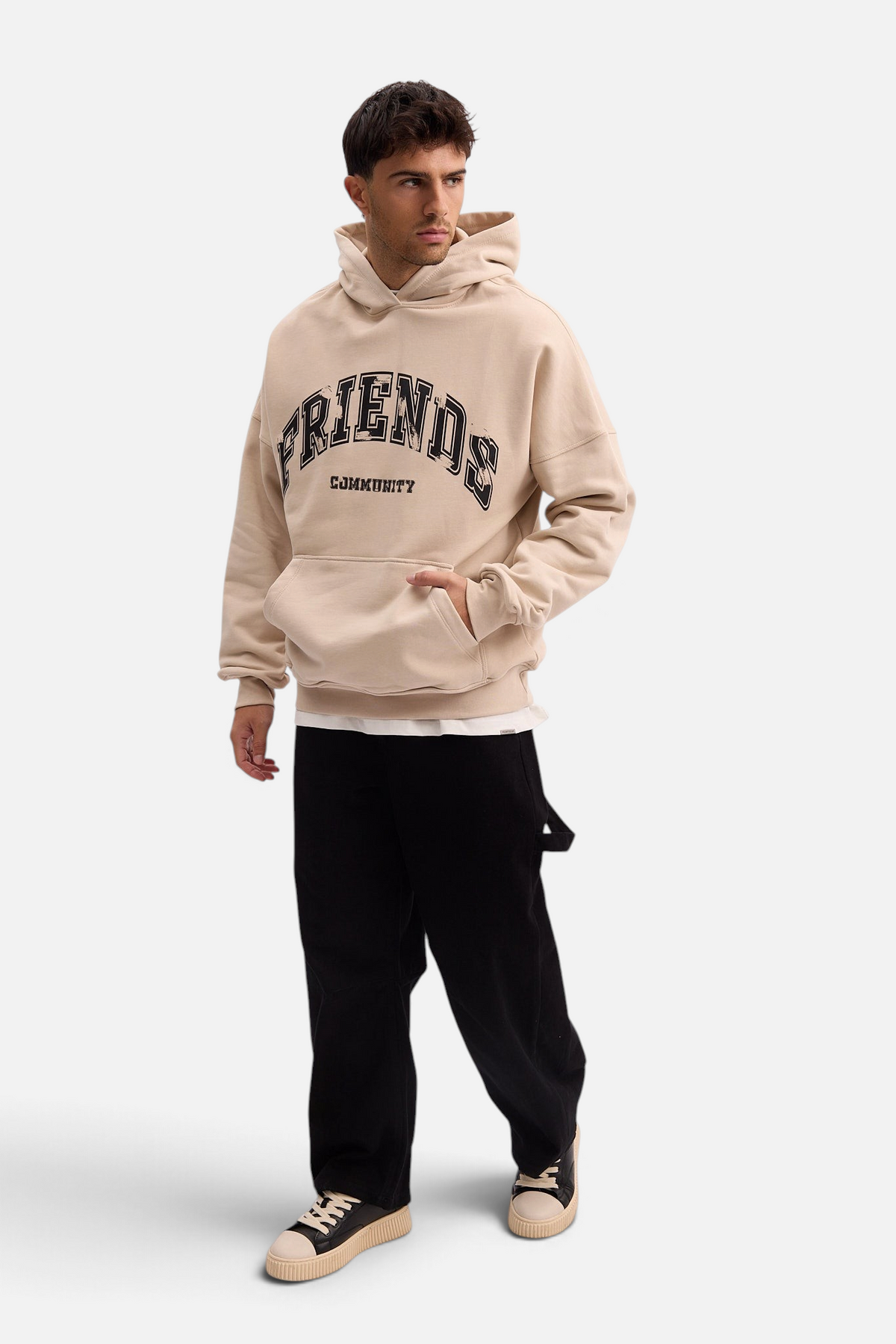 Mainstreamonline beige oversized Social Club hoodie with black graphic text, worn by a man with black trousers