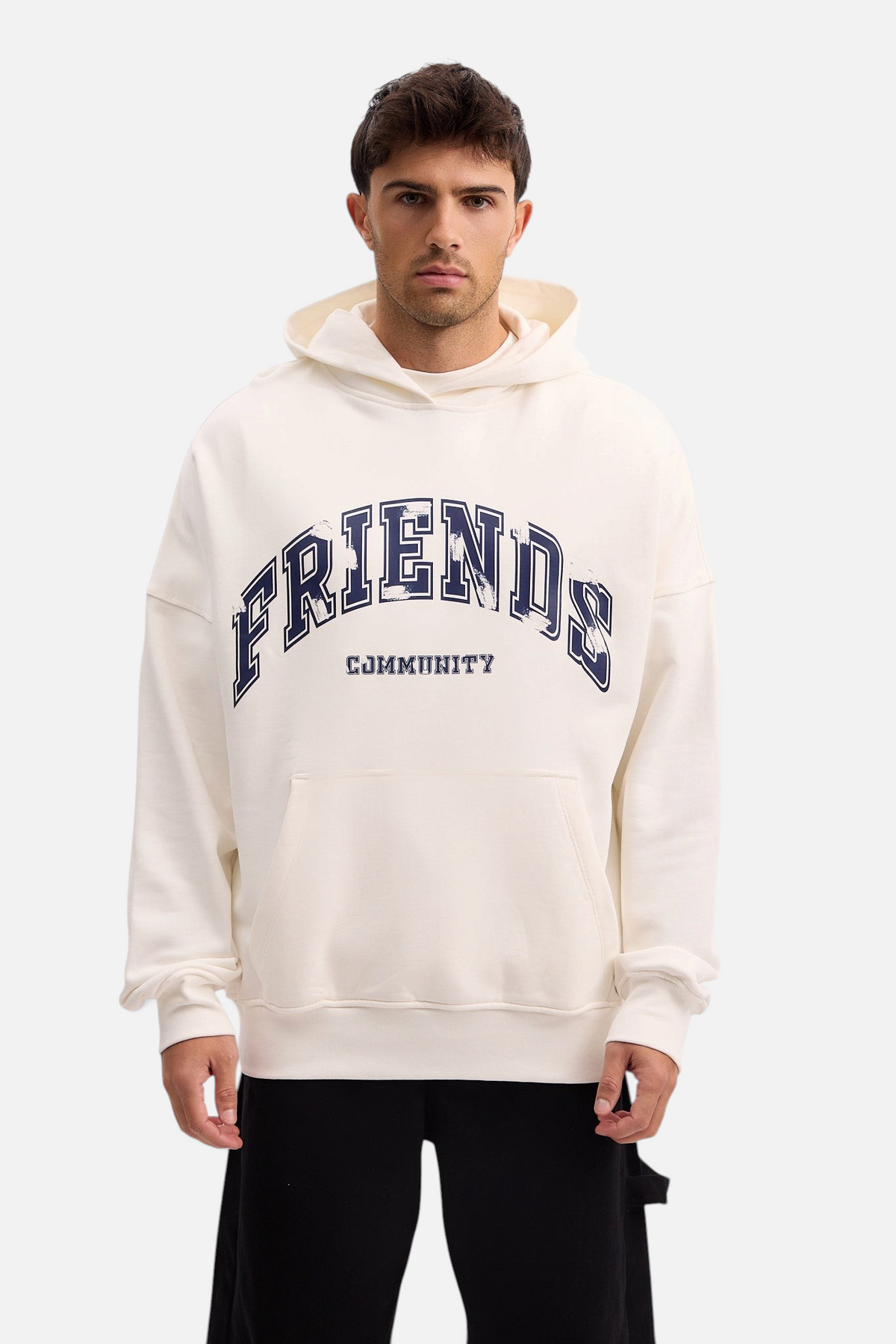 Mainstreamonline oversized cream hoodie with Friends Community graphic print worn by a male model