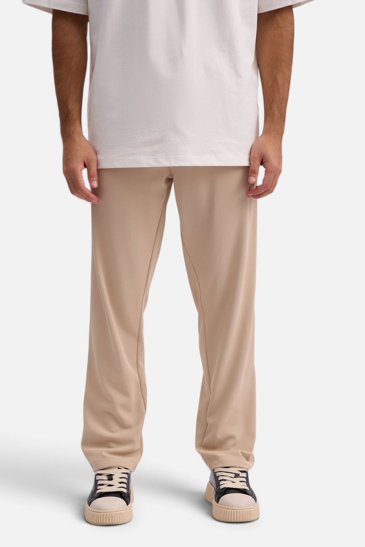 Mainstreamonline Sol Pants in beige featuring a relaxed straight-leg fit, elastic waistband, and side pockets.