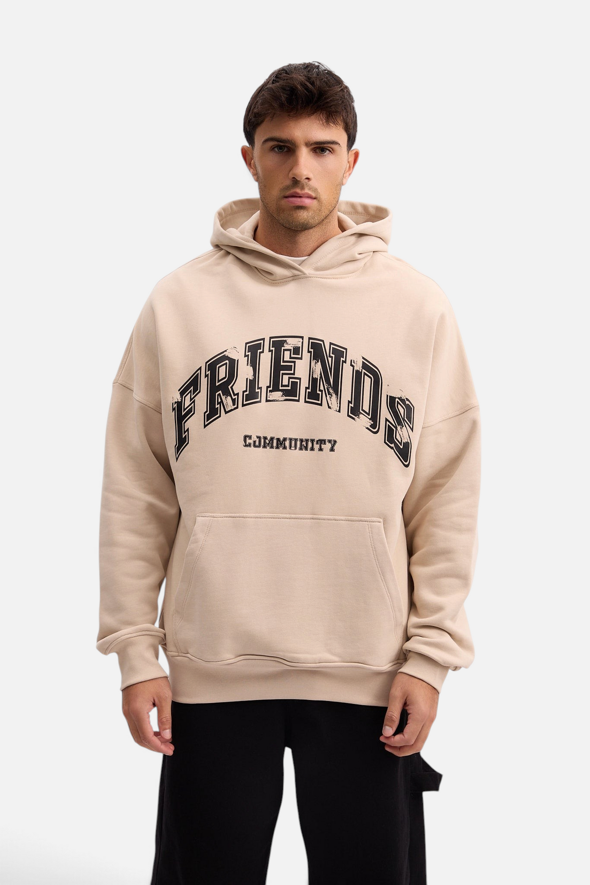 Mainstreamonline oversized beige hoodie with Friends Community graphic print worn by a male model