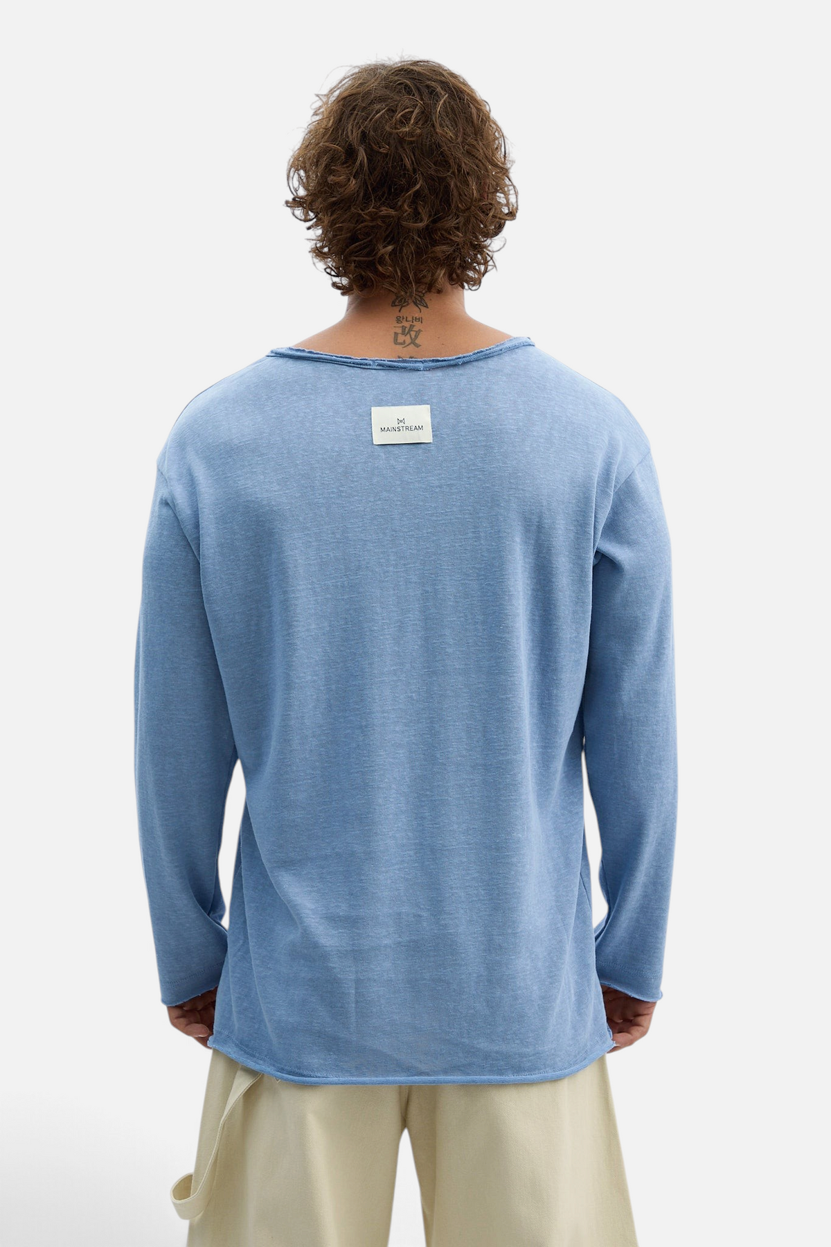 Mainstreamonline blue long-sleeve oversized t-shirt with raw edge neckline and back brand label, back view