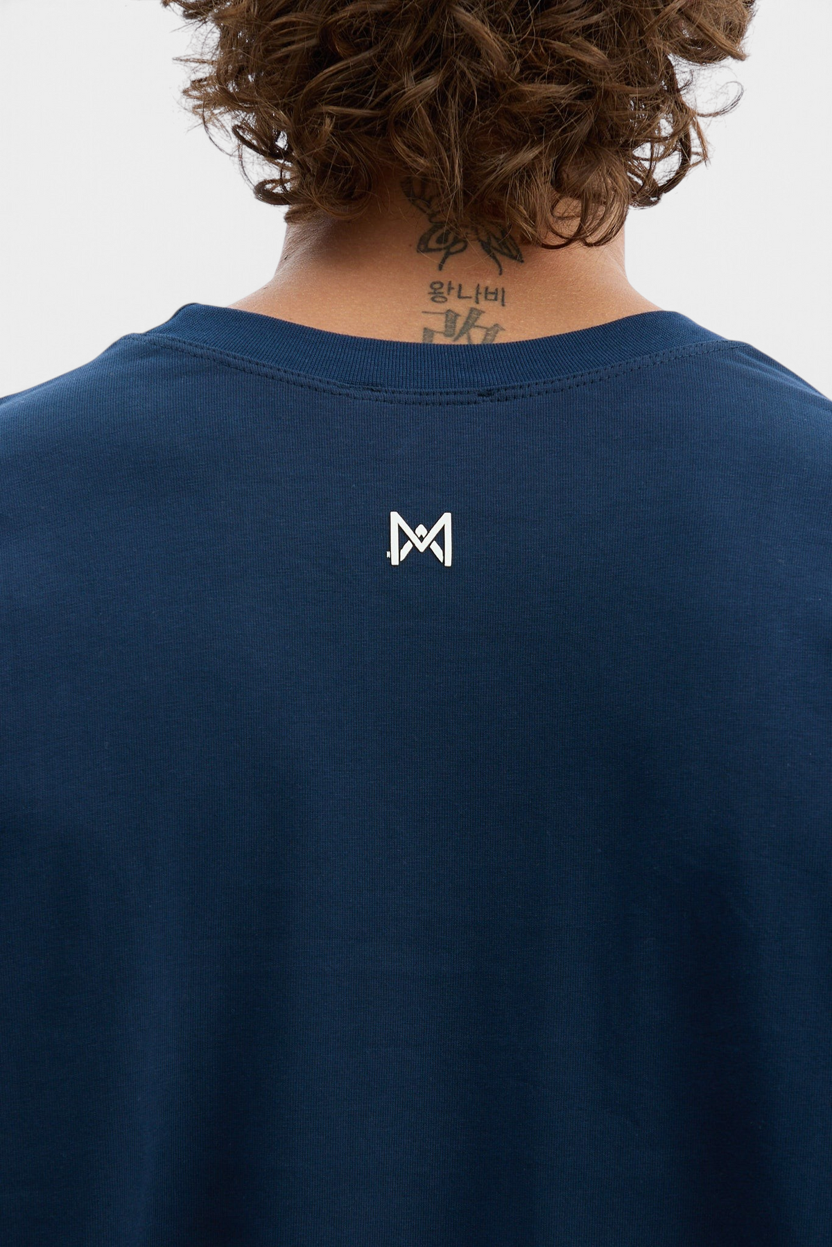 Mainstreamonline navy blue oversized long sleeve t-shirt with a small white logo detail on the back neckline