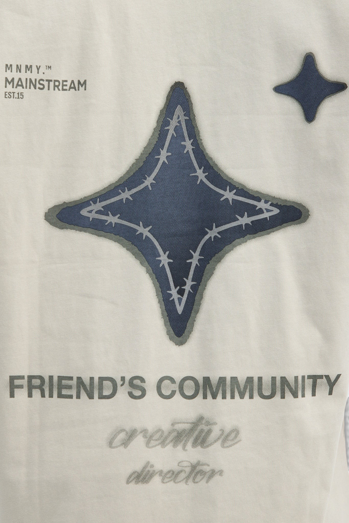 Mainstreamonline oversized t-shirt in cream with a dark blue star graphic featuring barbed wire and text details.