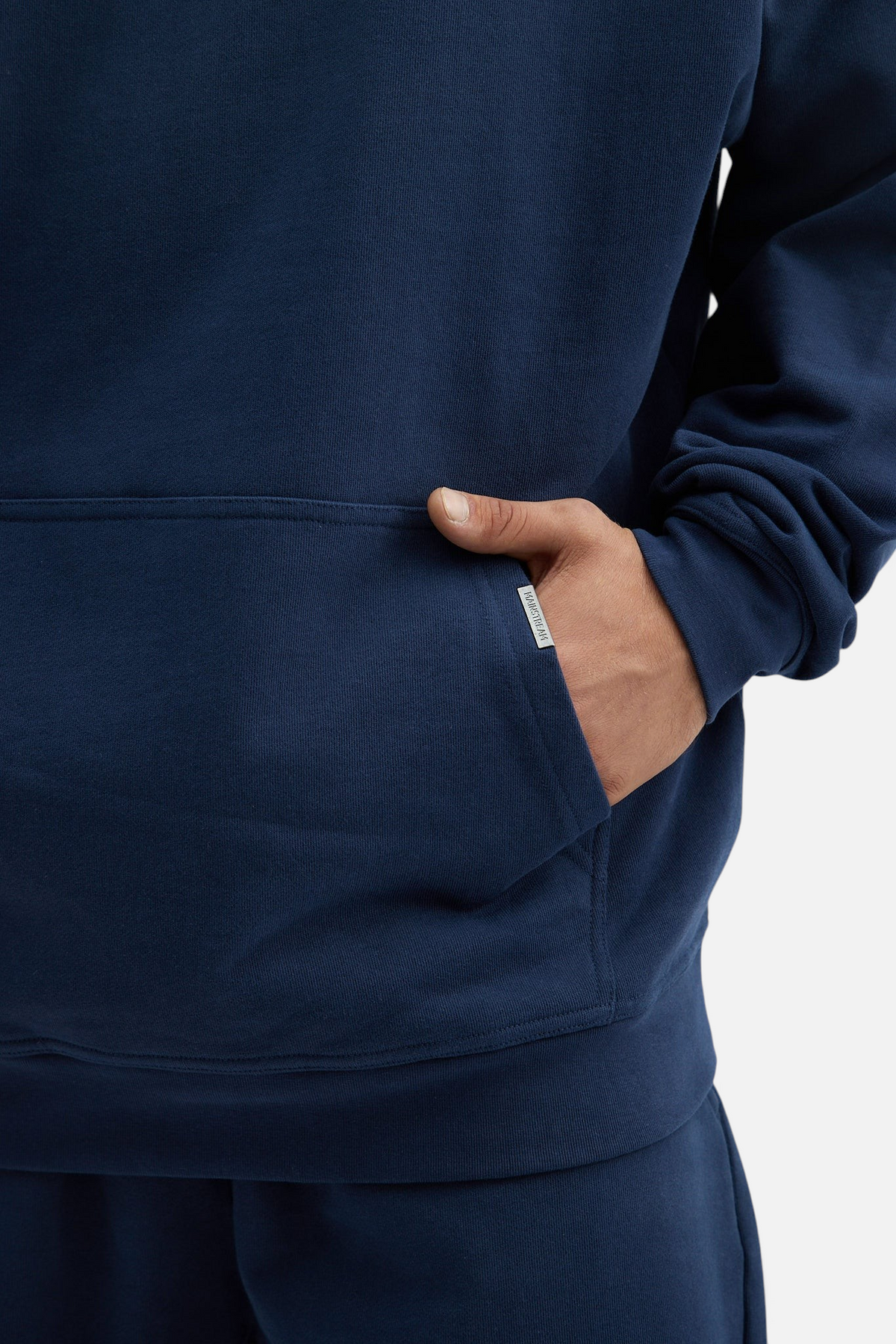 Mainstreamonline navy blue oversized hoodie with a front kangaroo pocket and small branded side tab detail