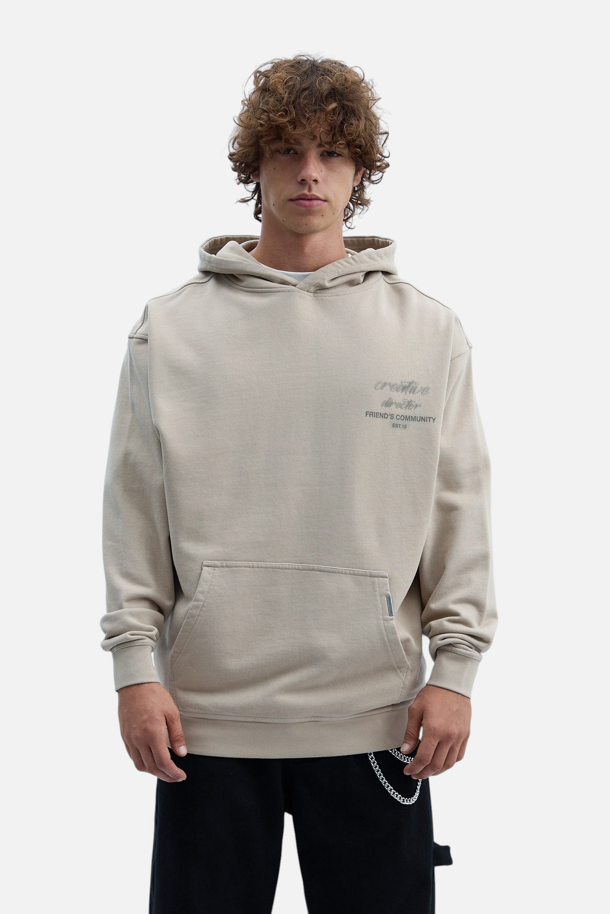 Mainstreamonline Luminous oversized beige hoodie with front pocket and creative director graphic on chest