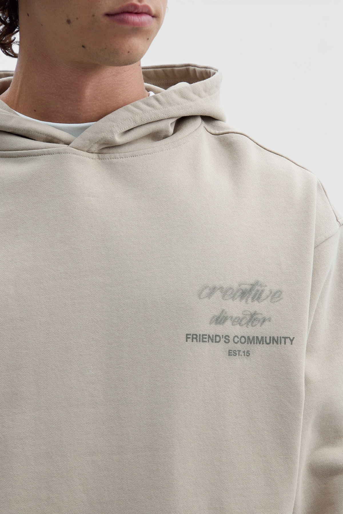 Mainstreamonline beige oversized hoodie with creative director graphic print on chest