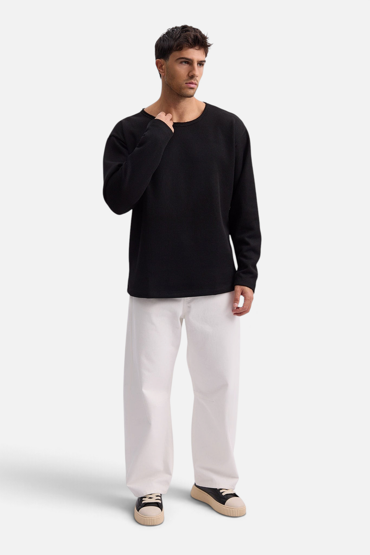 Mainstreamonline Sean Knit black oversized sweater worn by a male model with white trousers