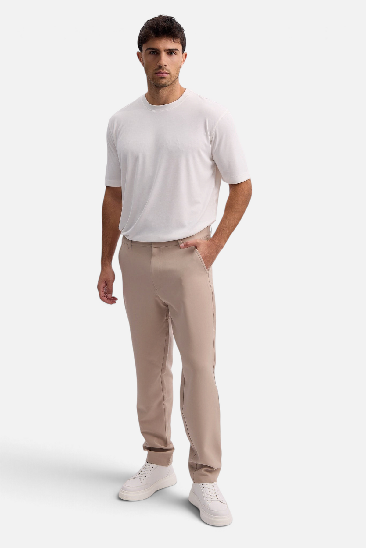 Mainstreamonline Santo Pants in beige with a relaxed wide-leg fit worn by a male model with a white t-shirt