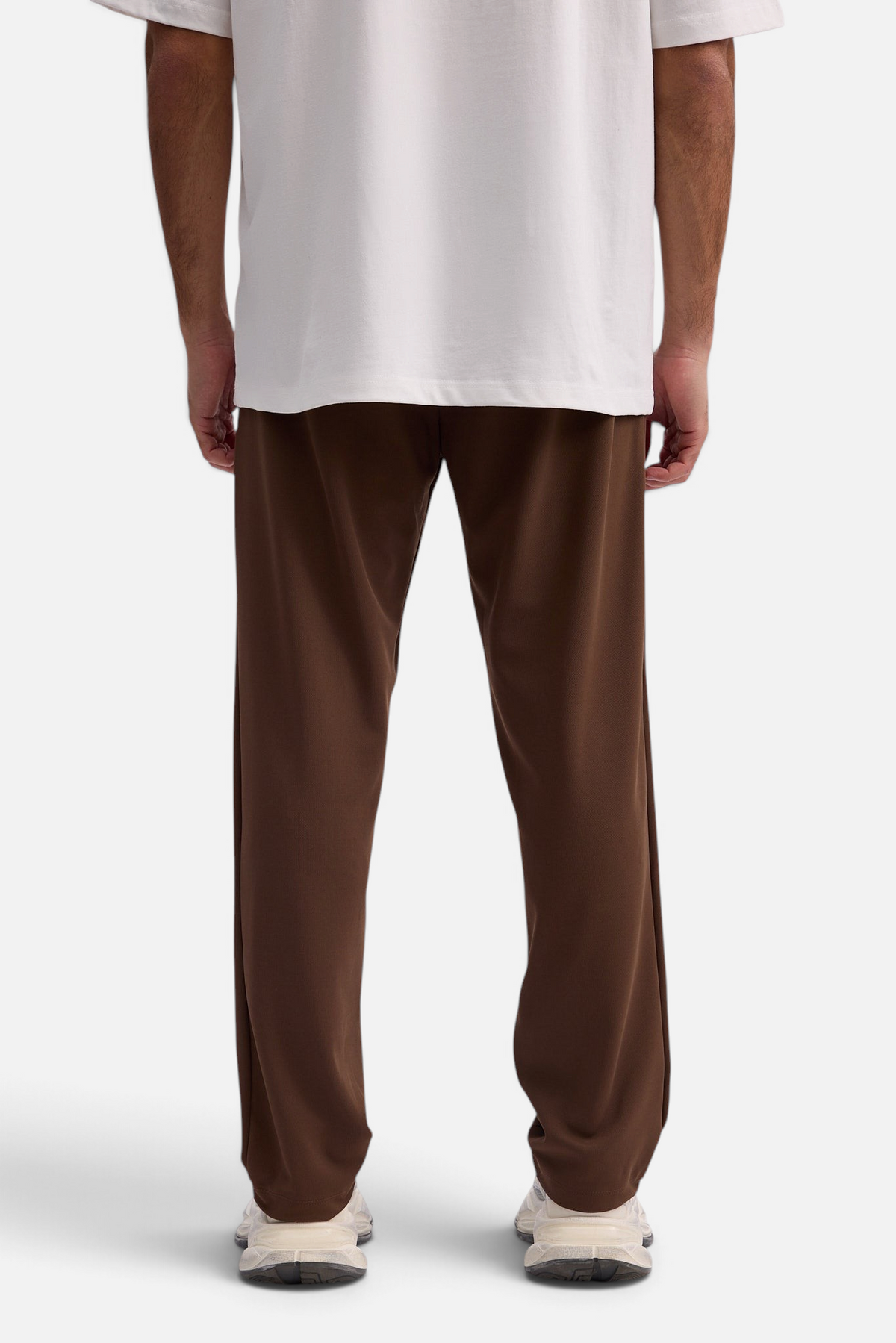 Mainstreamonline Sol Pants in brown with a relaxed straight fit, worn by a model from the back view.
