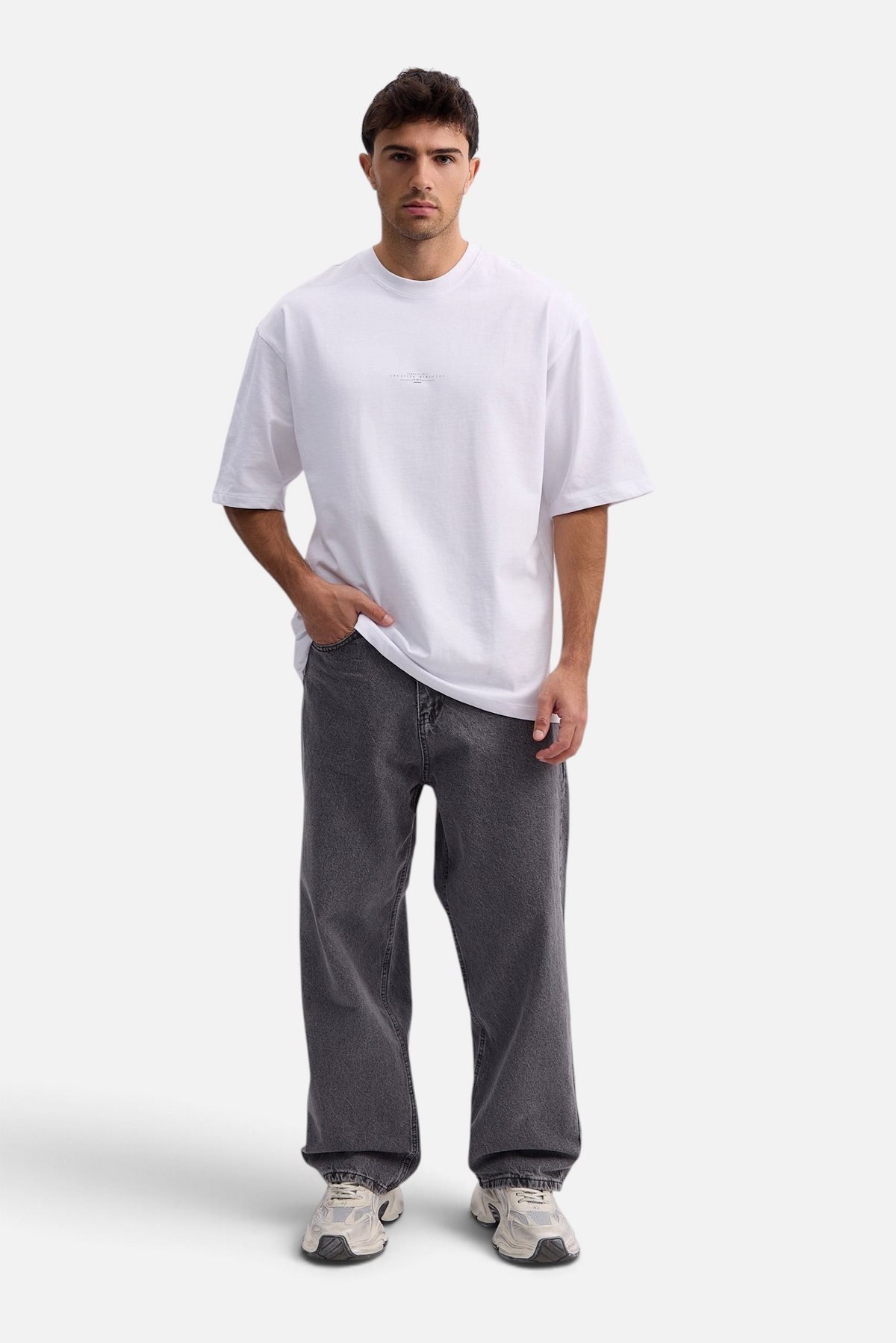 Mainstreamonline baggy skater jeans in washed charcoal grey worn by a male model with a white t-shirt