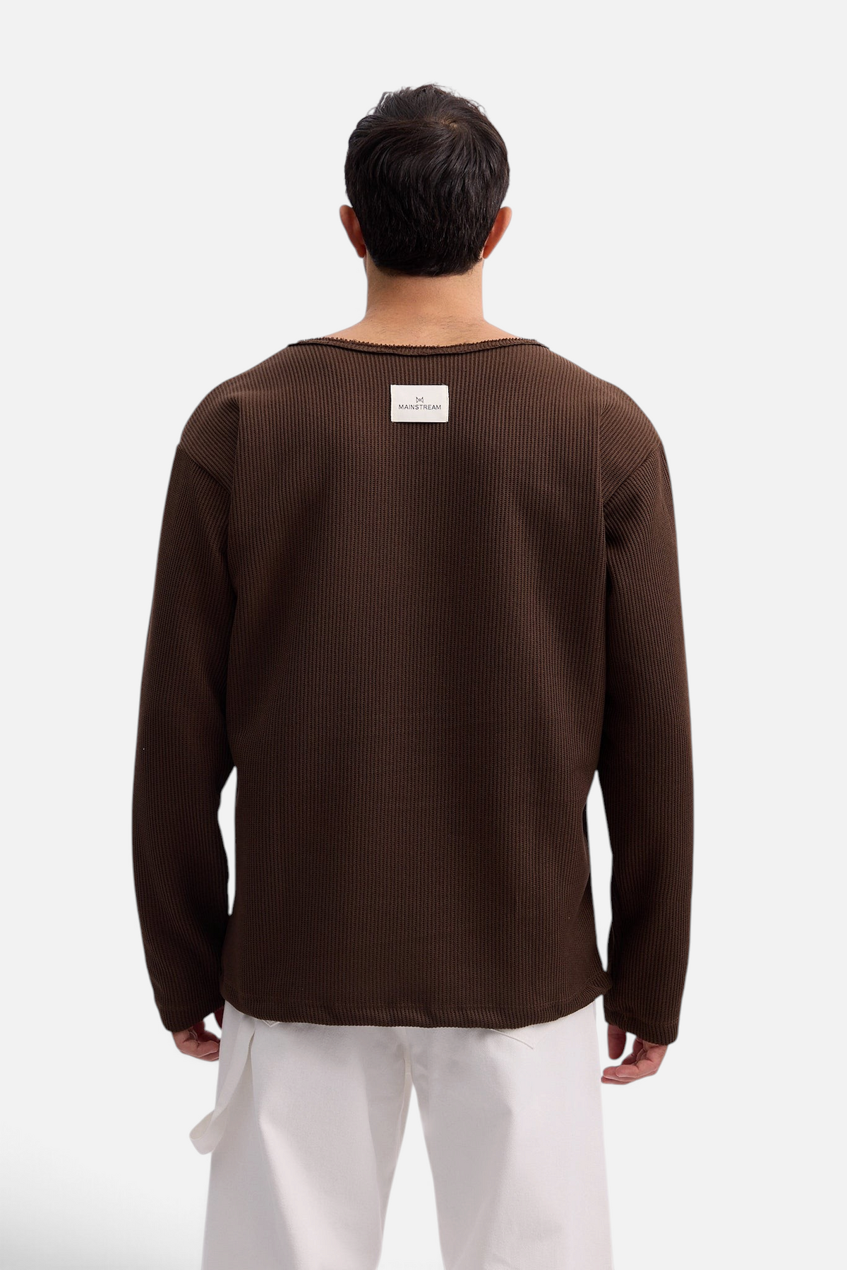Mainstreamonline Sean Knit oversized brown ribbed sweater with back label detail worn by a man