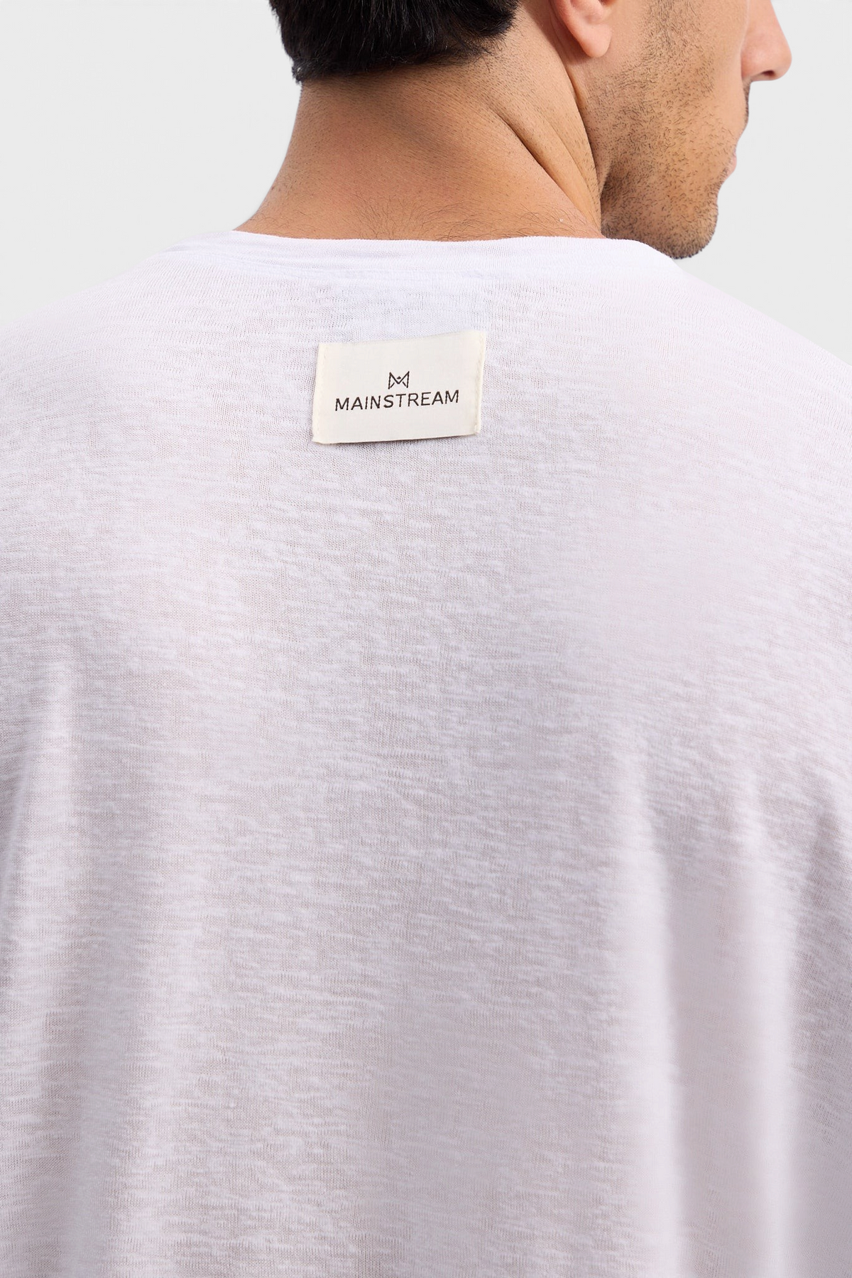 Mainstreamonline white linen long sleeve t-shirt with a relaxed oversized fit and branded label on the back neck