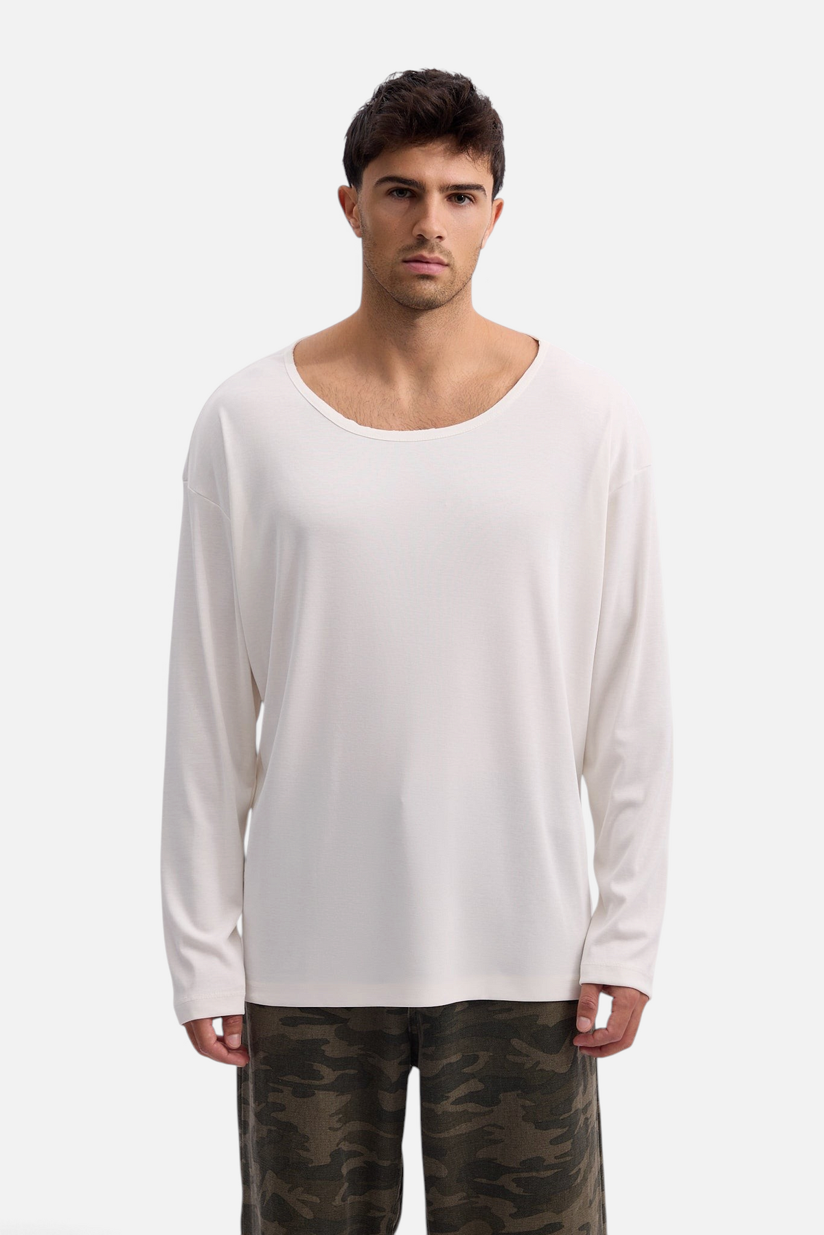 Mainstreamonline Niki long sleeve oversized white t-shirt with a wide scoop neck worn by a male model