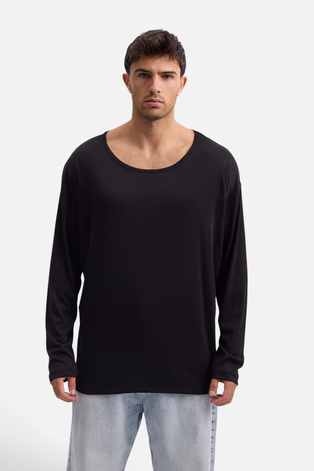 Mainstreamonline Niki long sleeve black oversized t-shirt worn by a male model with a wide scoop neckline