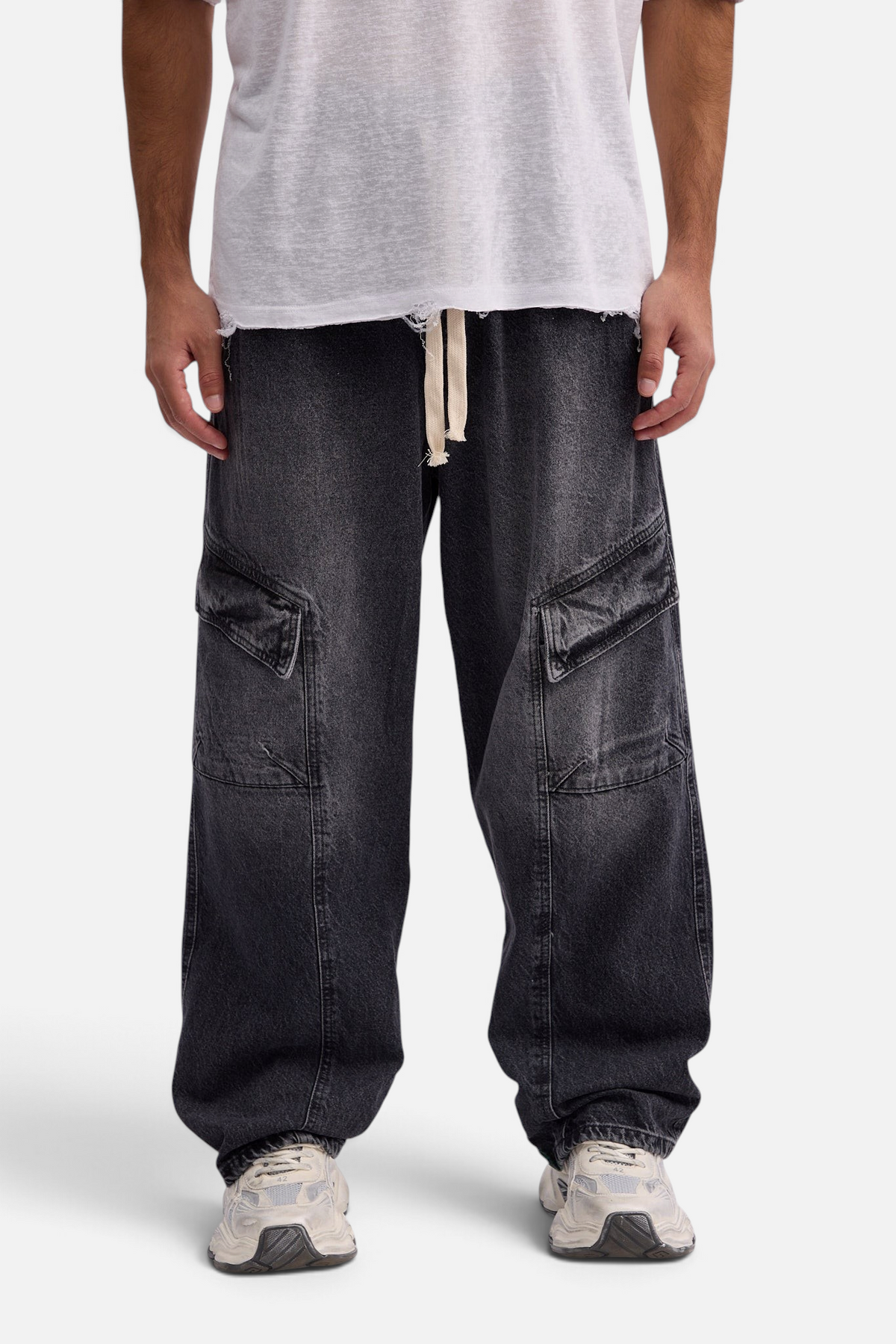 Mainstreamonline baggy skater jeans in washed black denim with large side cargo pockets and a drawstring waist