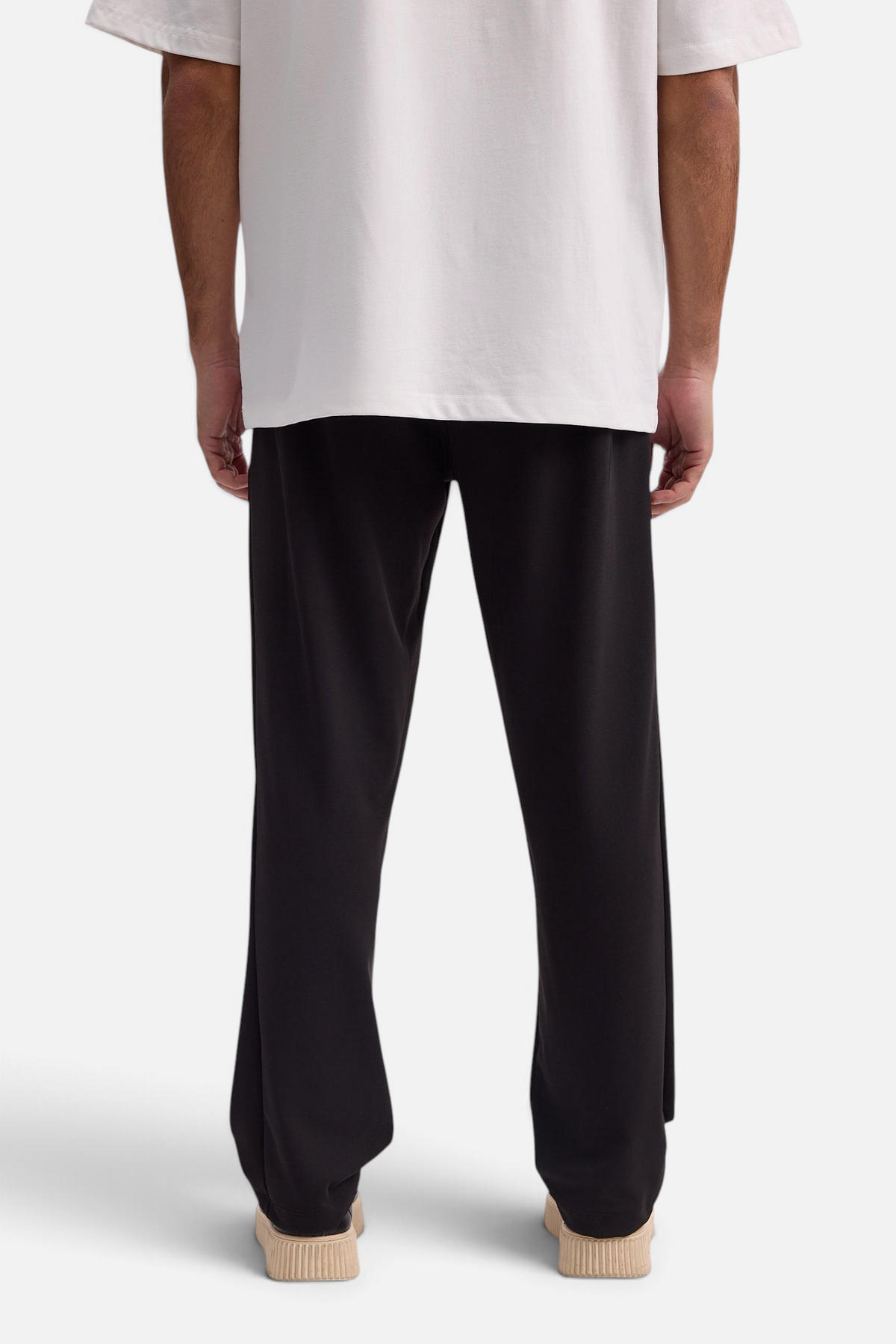 Mainstreamonline Sol Pants in black with a relaxed straight-leg fit, elastic waist, and side pockets, back view.