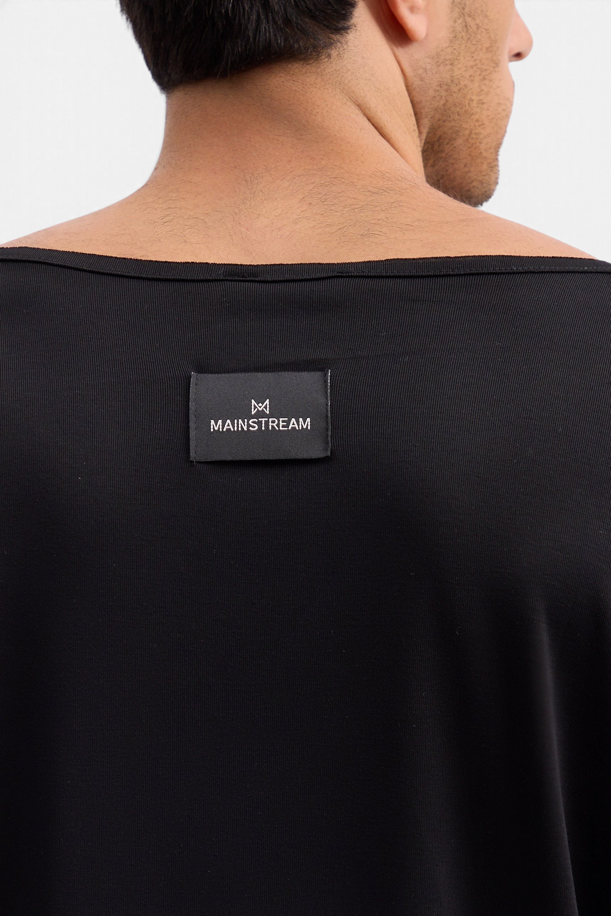Mainstreamonline Niki long sleeve black t-shirt with a wide neckline and branded back label