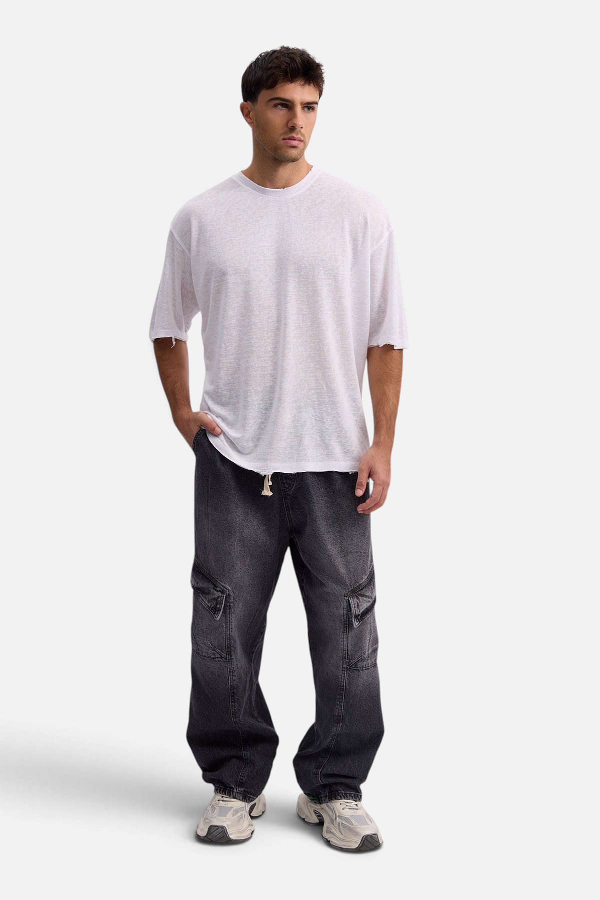 Mainstreamonline baggy skater jeans in washed black denim with cargo pockets worn by a male model