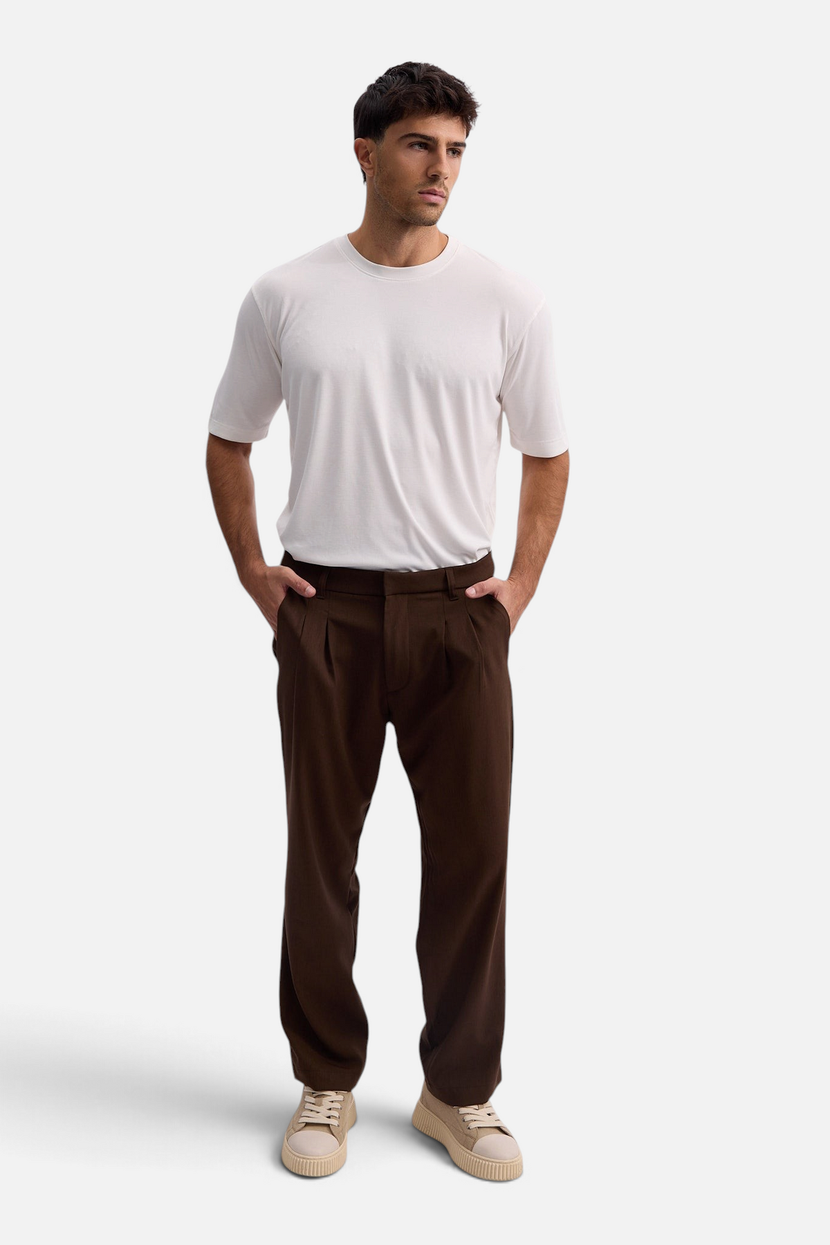 Mainstreamonline Max Pants in dark brown with a relaxed, moderate oversized fit worn by a male model