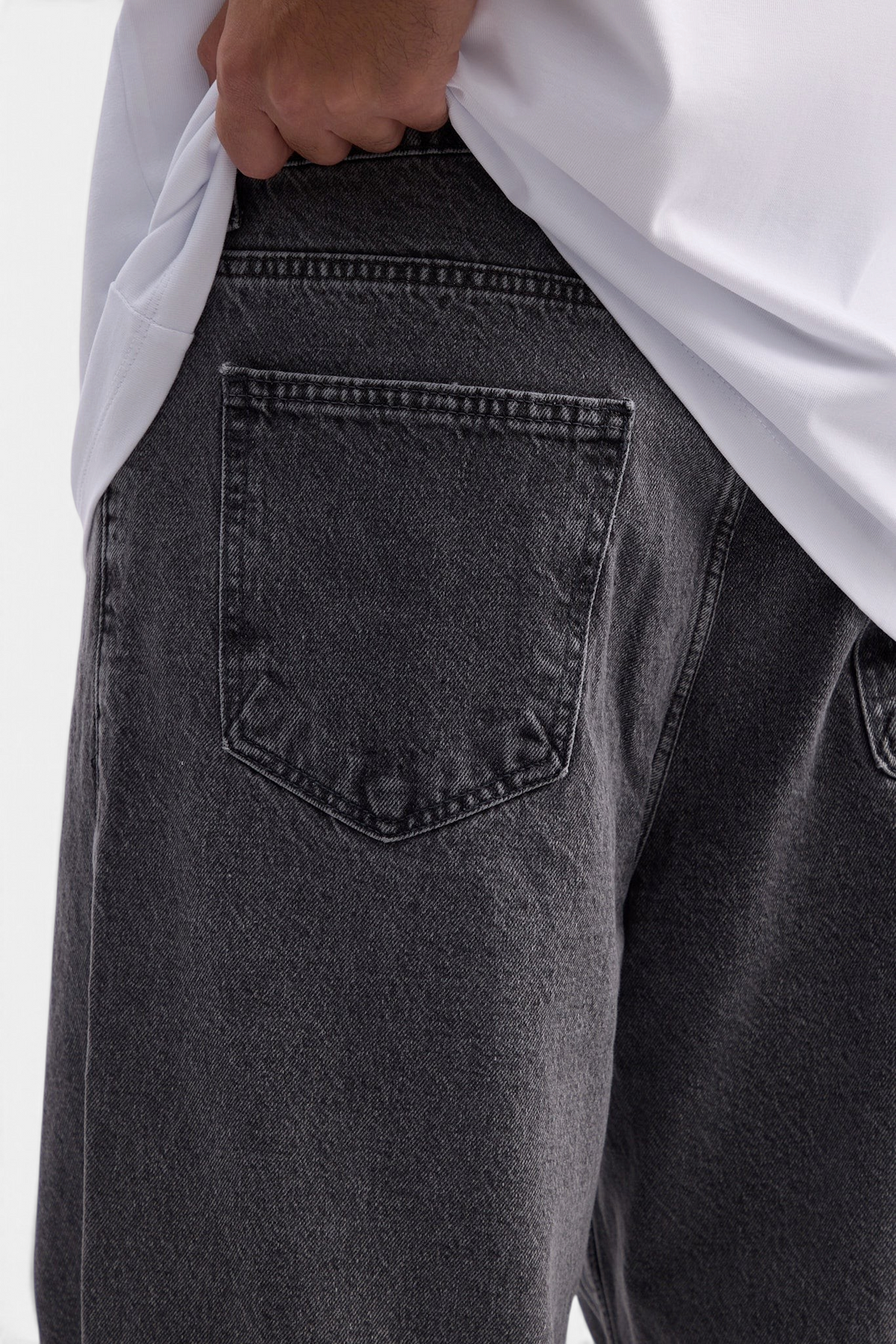Mainstreamonline baggy skater jeans in washed black denim with a loose fit and back pocket detail