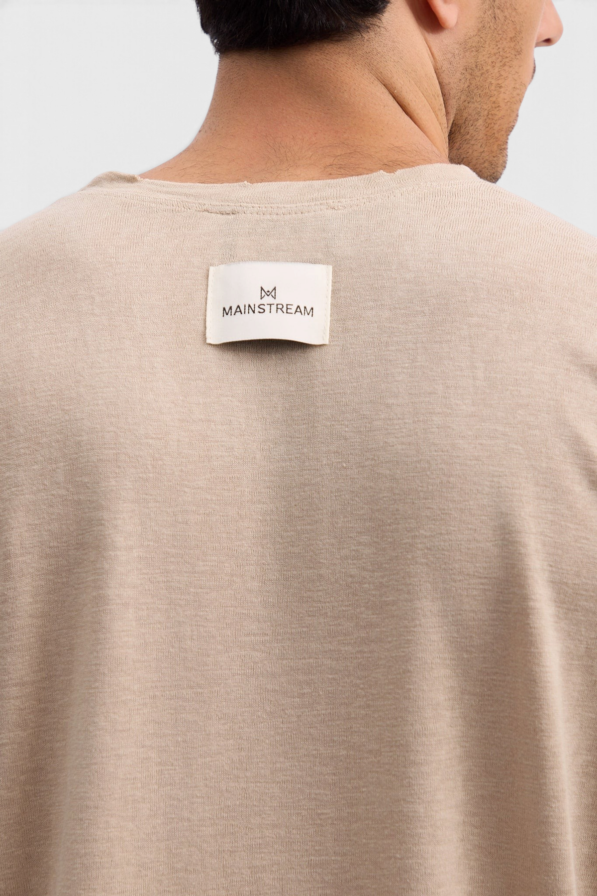 Mainstreamonline beige linen long sleeve t-shirt with raw edge neckline and branded back label