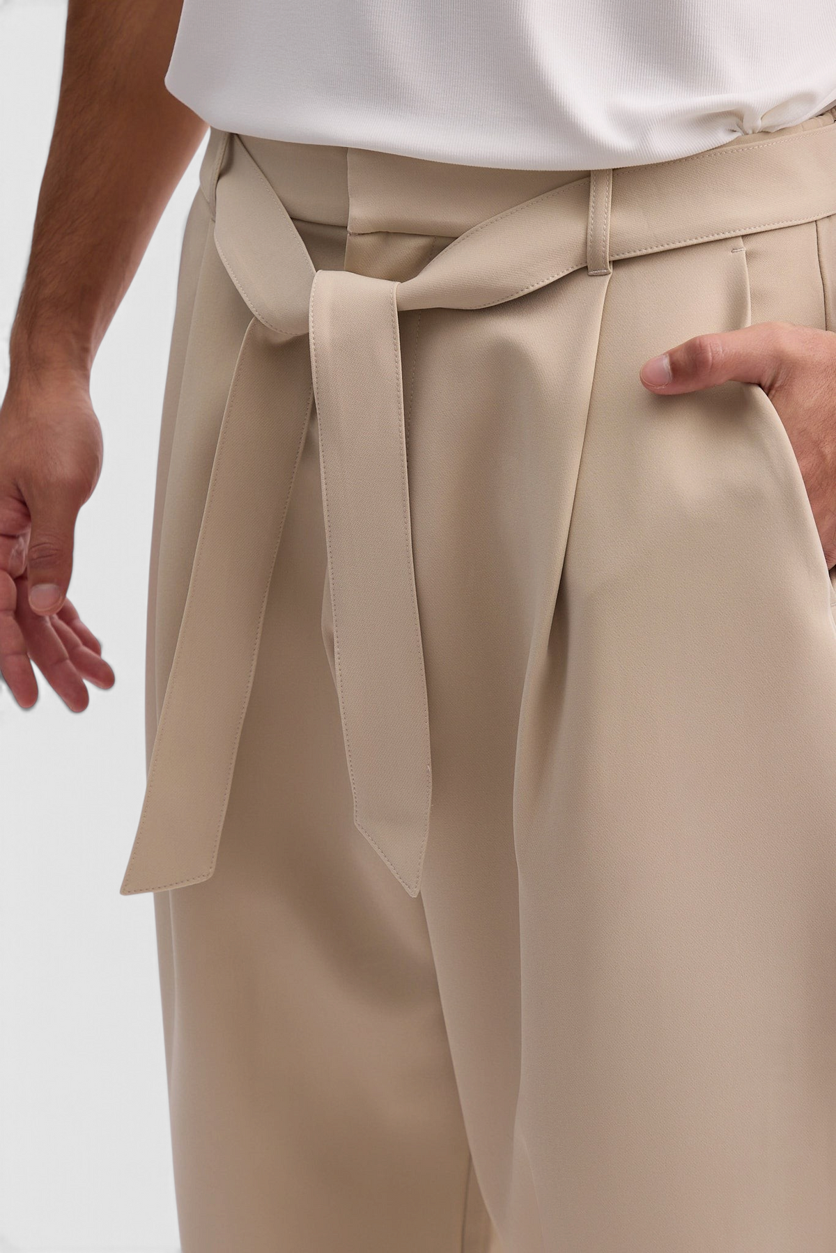 Mainstreamonline Torino wide-leg beige trousers with a fabric waist tie and side pockets on a male model