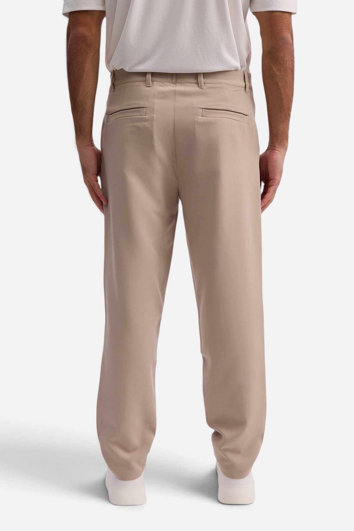 Mainstreamonline Santo Pants in beige featuring a relaxed wide-leg tailored fit, back view on a male model.