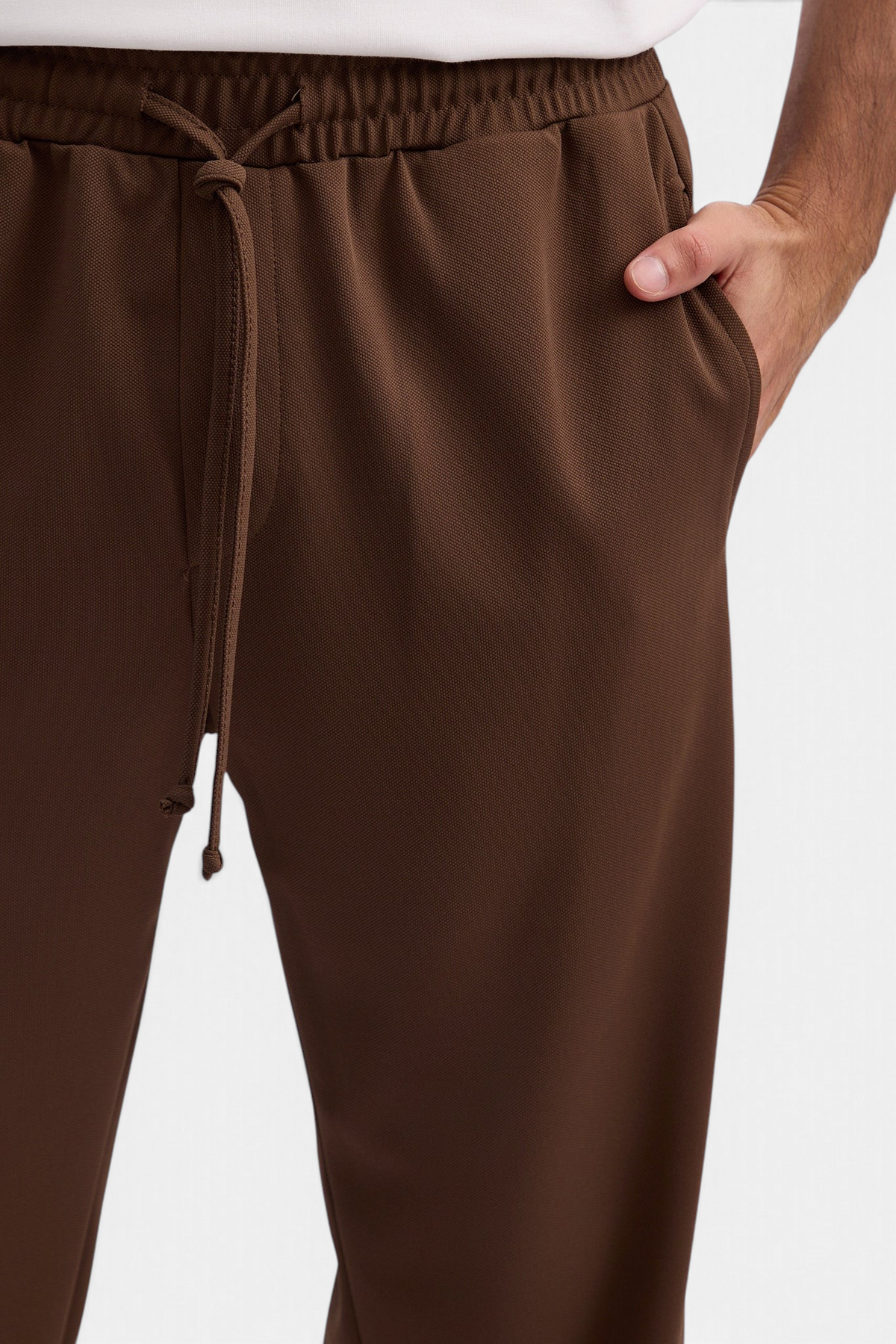 Mainstreamonline brown Sol casual pants with an elastic waistband, drawstring, and side pockets on a model
