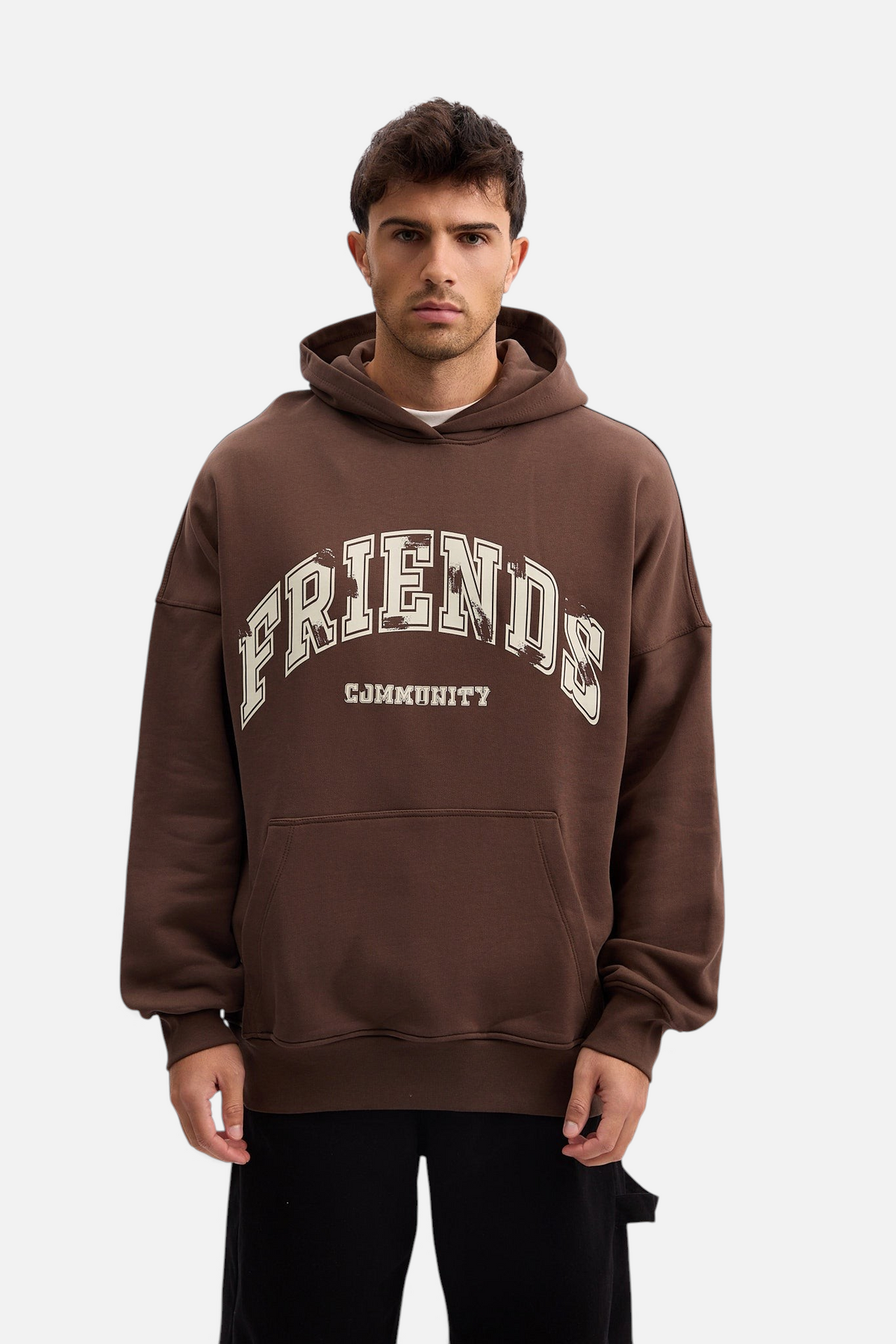 Mainstreamonline brown oversized hoodie with Friends Community graphic print worn by a male model