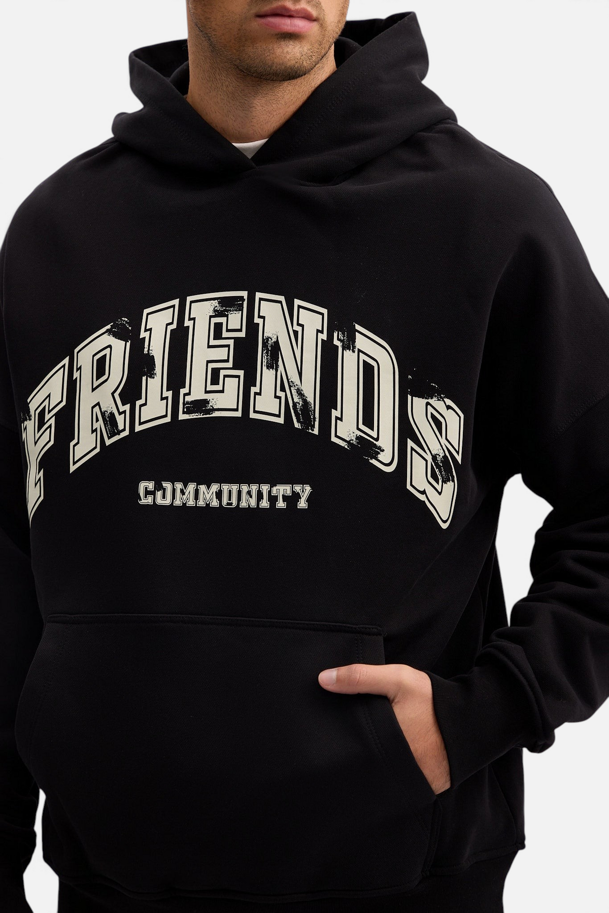 Mainstreamonline black oversized hoodie featuring white distressed Friends Community graphic print and front pocket