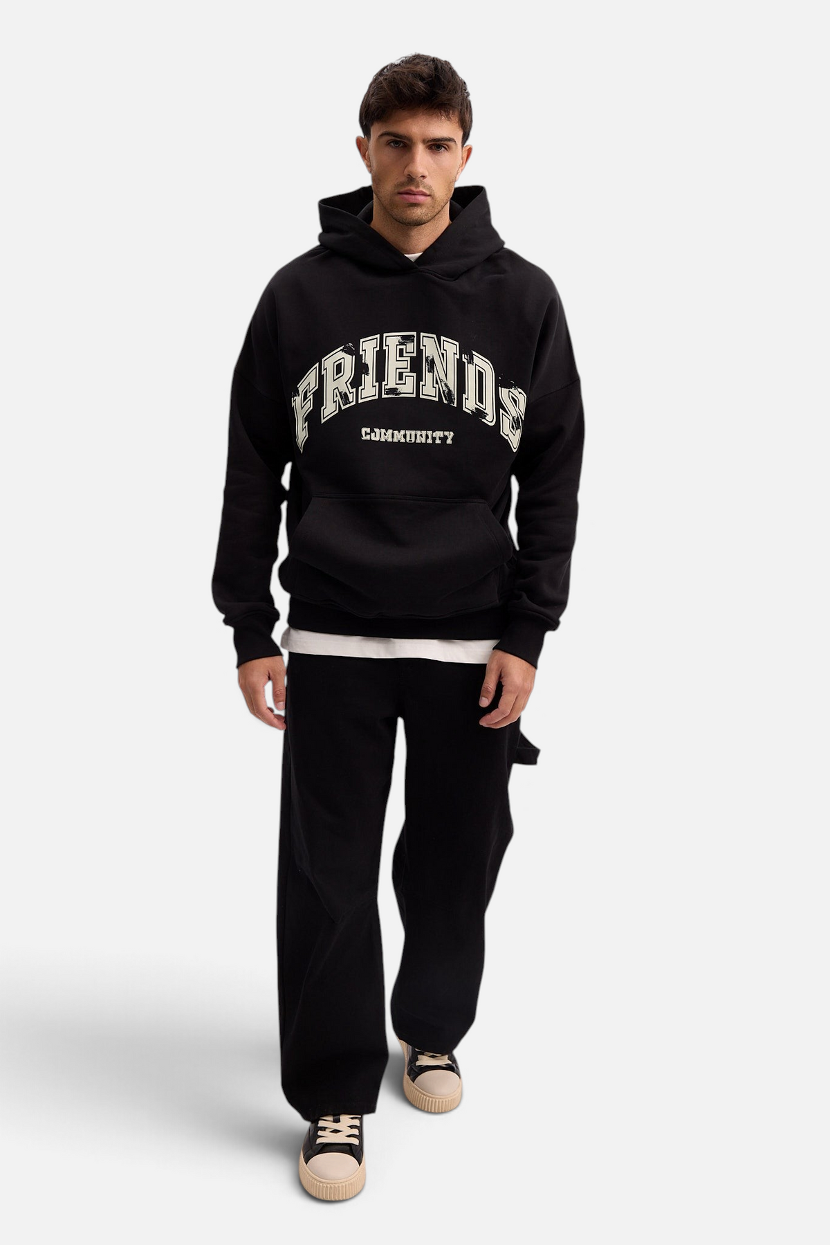 Mainstreamonline black oversized hoodie with Friends Community graphic print worn by a male model