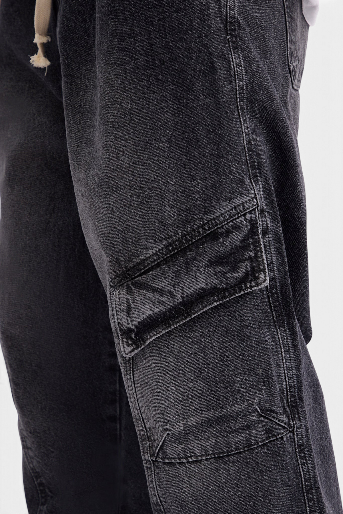 Mainstreamonline baggy skater jeans in washed black denim with a side cargo pocket and drawstring waist