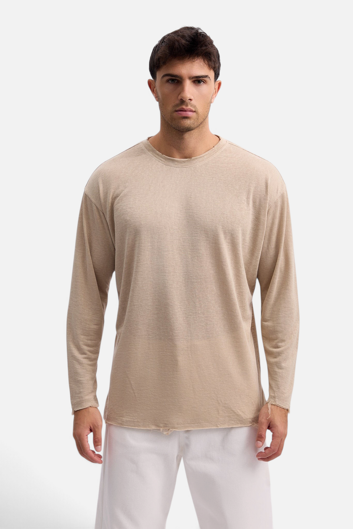 Mainstreamonline beige linen long sleeve t-shirt with a relaxed oversized fit and raw hem detail worn by a man