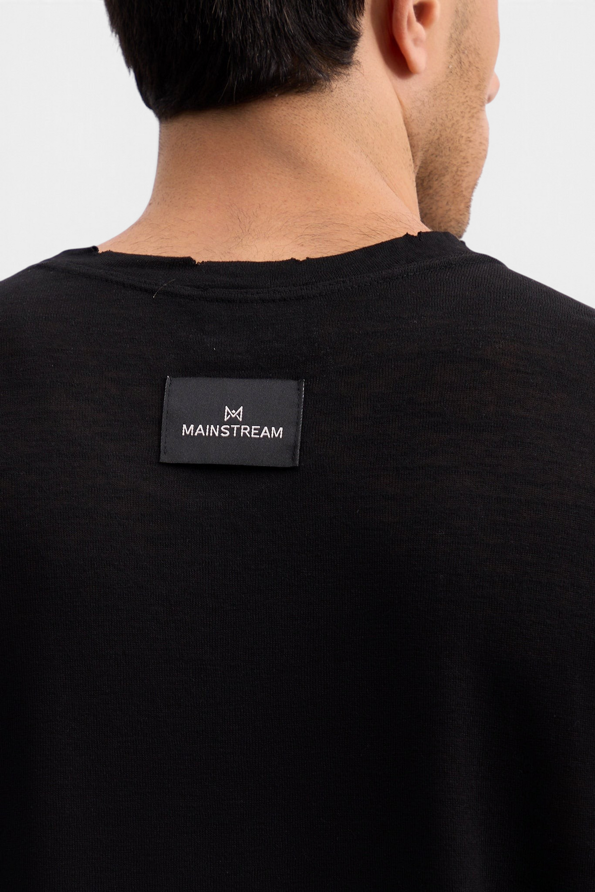 Mainstreamonline black linen long sleeve t-shirt with a raw edge neckline and branded back label