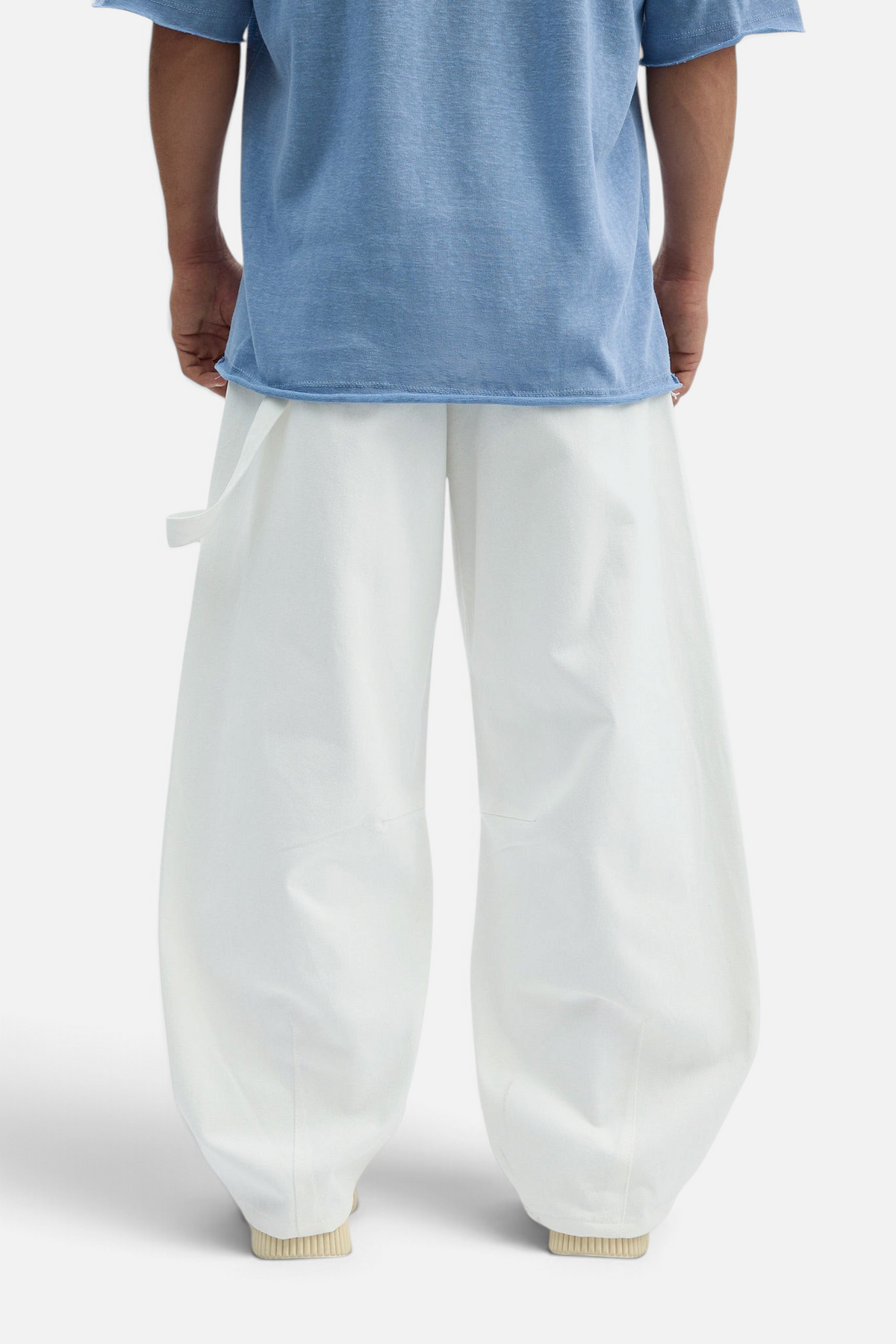 Mainstreamonline white loose-fit drill pants with a relaxed wide-leg silhouette worn with a blue t-shirt