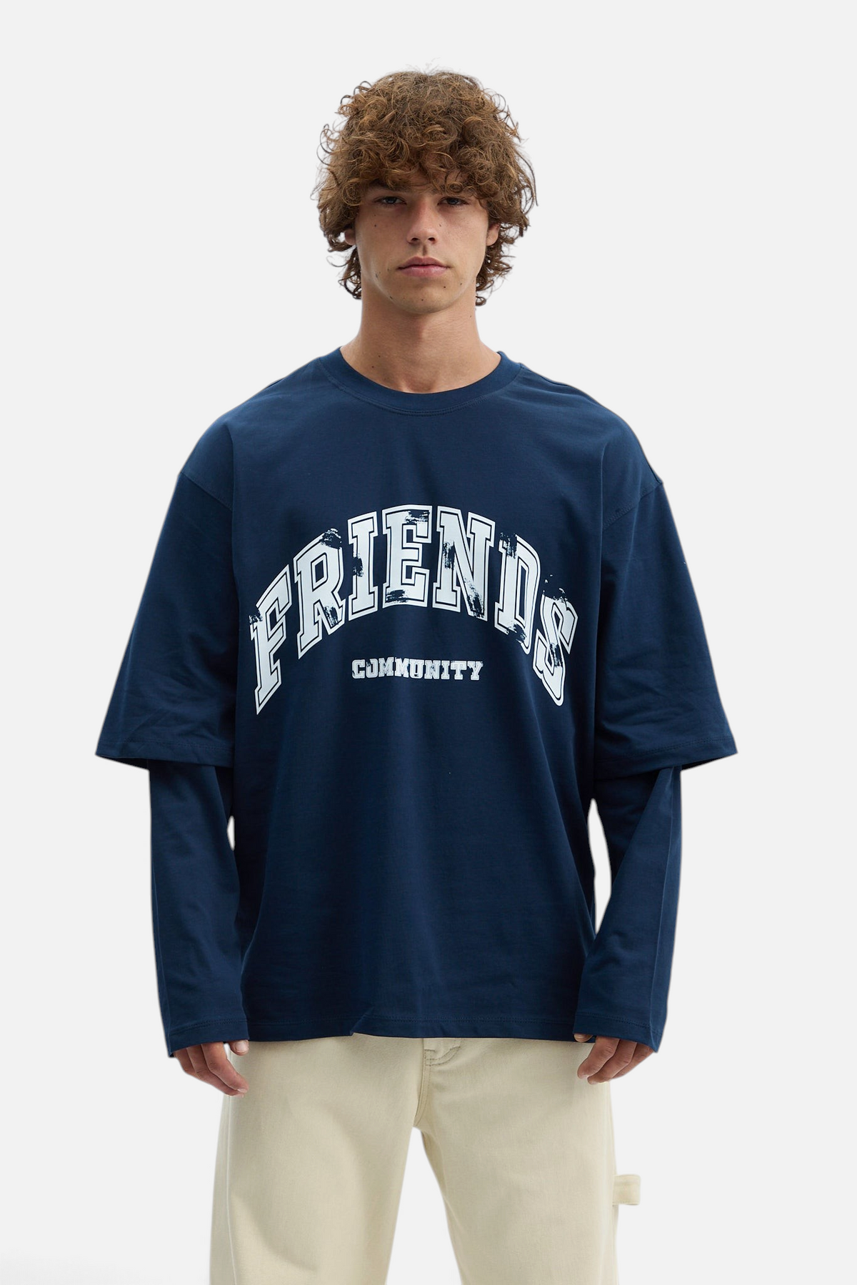Mainstreamonline navy blue oversized long sleeve t-shirt with Friends Community graphic print on a male model