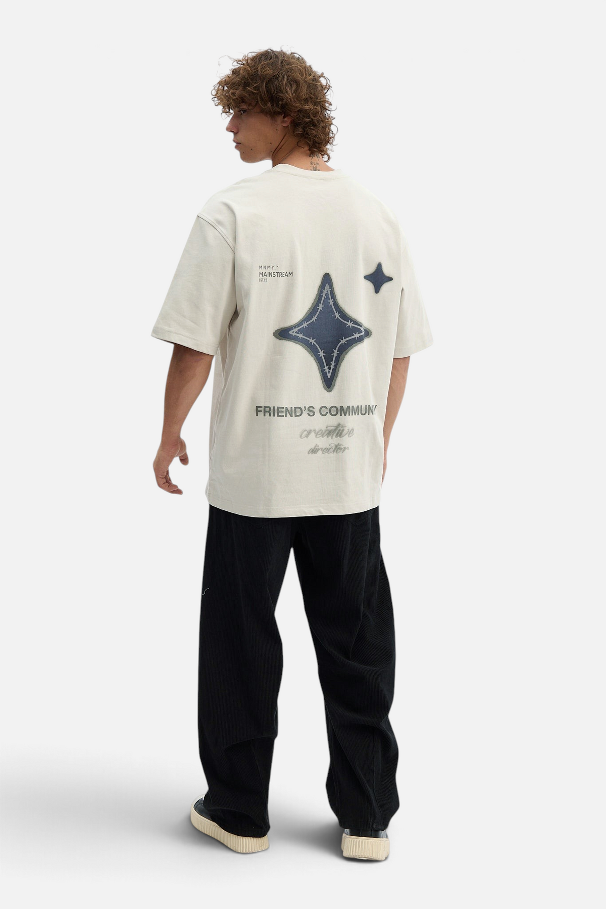 Mainstreamonline oversized beige t-shirt with back star graphic and text print worn by a man