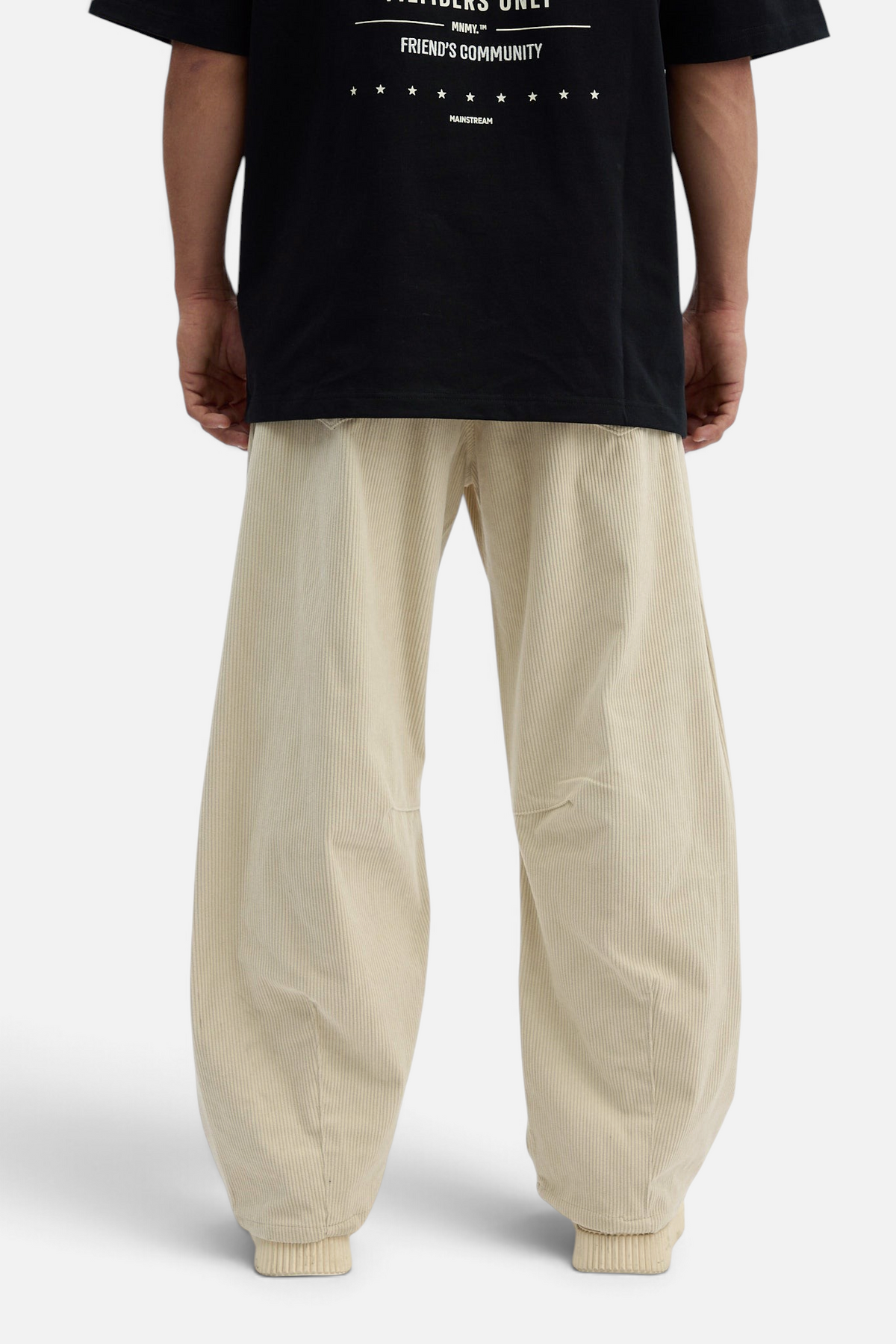 Mainstreamonline beige corduroy baggy pants with a loose, relaxed fit and ribbed cuffs, back view.