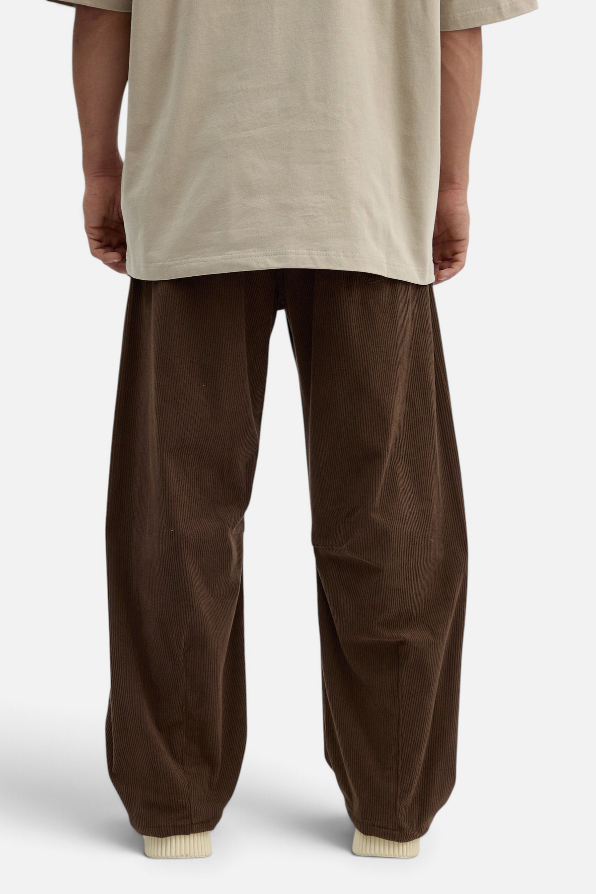 Mainstreamonline brown corduroy baggy pants with a loose, relaxed fit worn with a beige t-shirt