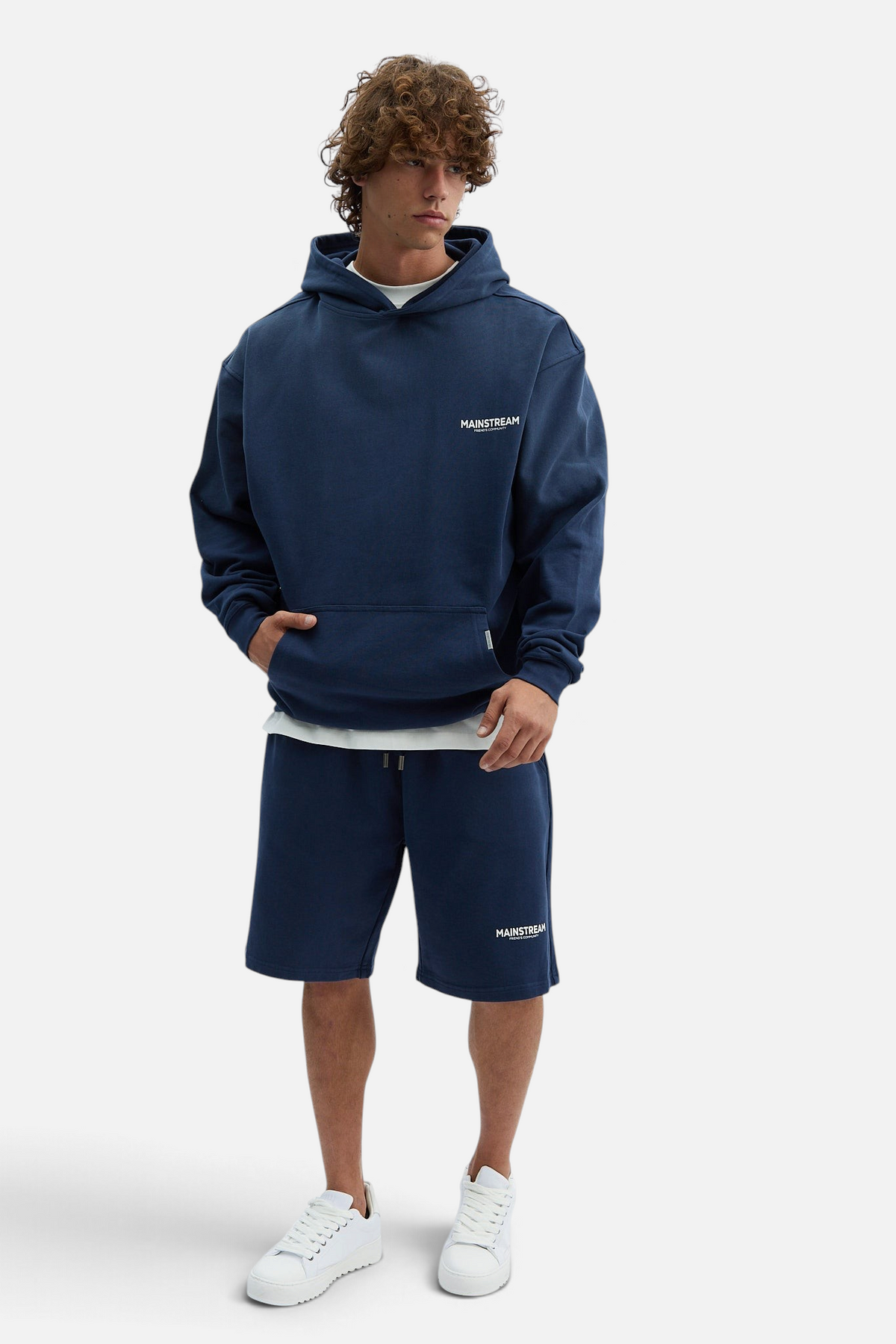 Mainstreamonline oversized navy blue hoodie with a relaxed fit and front pocket worn by a male model